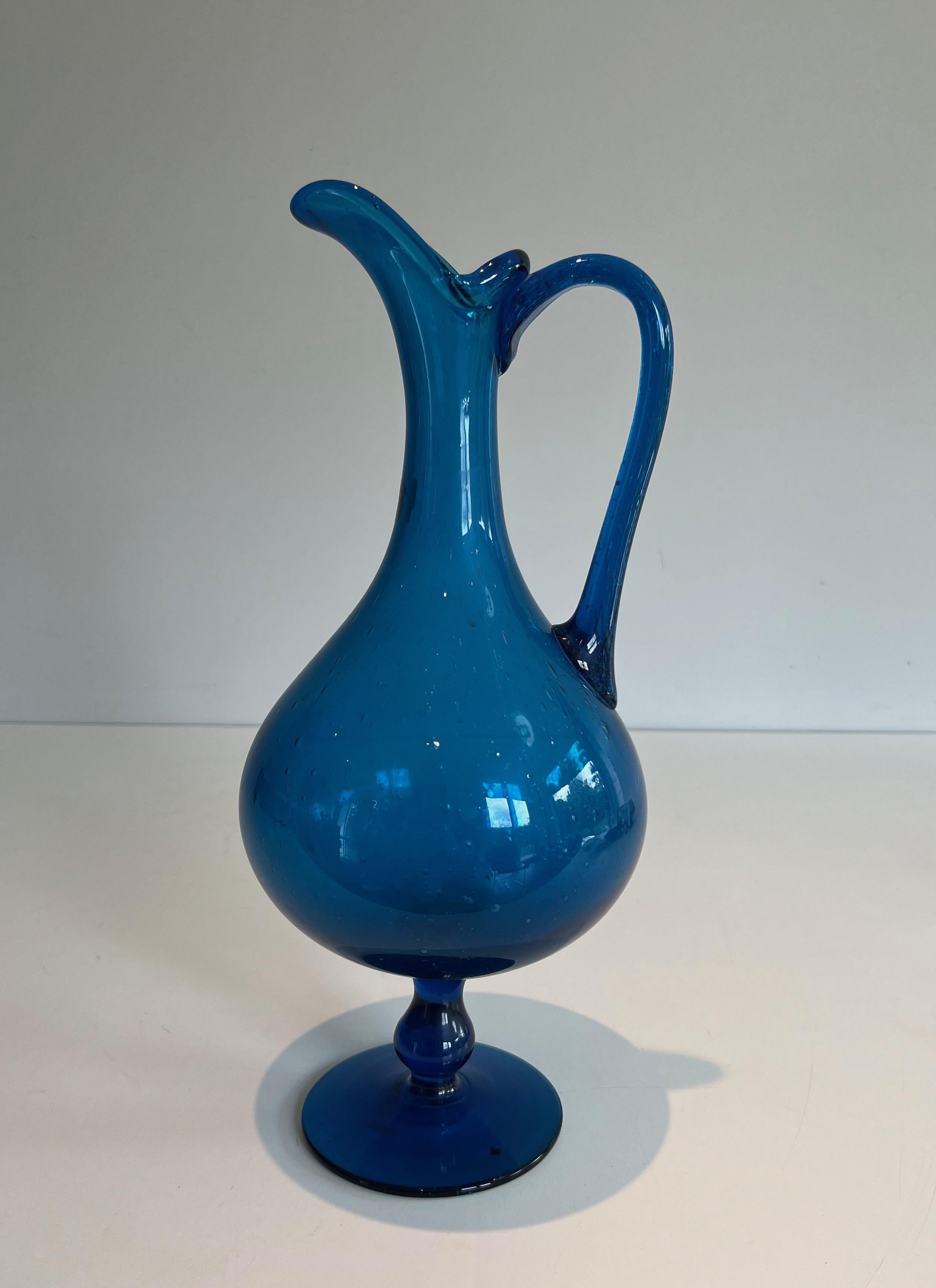 This blueish pitcher is made of glass. This is an Italian firm signed Still Novo (Sticker). Circa 1970