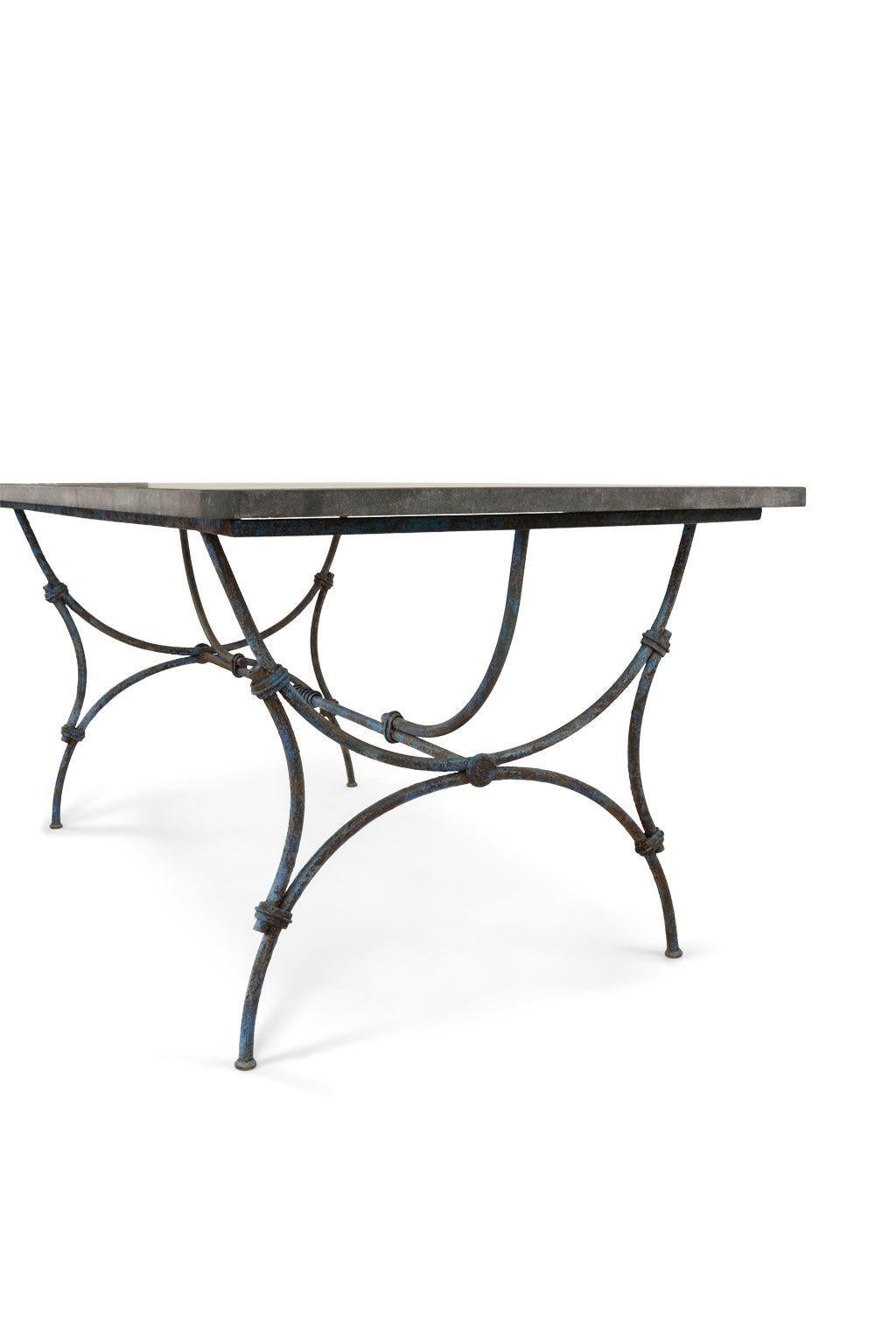 Bluestone top iron garden table: rectangular thick bluestone top upon a painted 19th century forged iron trestle base. Gracefully-shaped arched legs.

Note: Finishes on antique and vintage metal will include some, or all, of the following: patina,