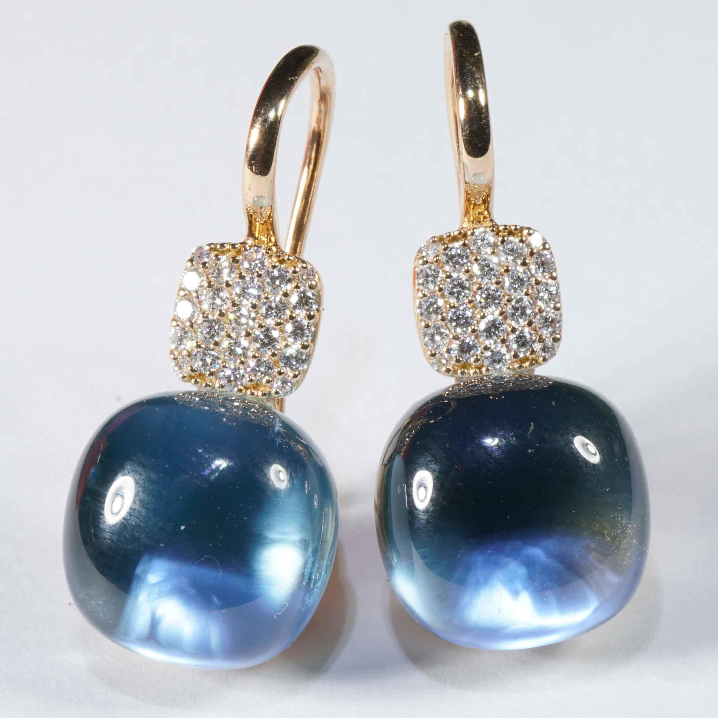 Earrings made in our traditional Italian goldsmiths in Valenza, modern design, earrings each with a skyblue light blue blue topaz cabochon measuring 11 x 11 mm in cushion shape, totaling approx. 19.35 ct, backed with mother of pearl for a magical