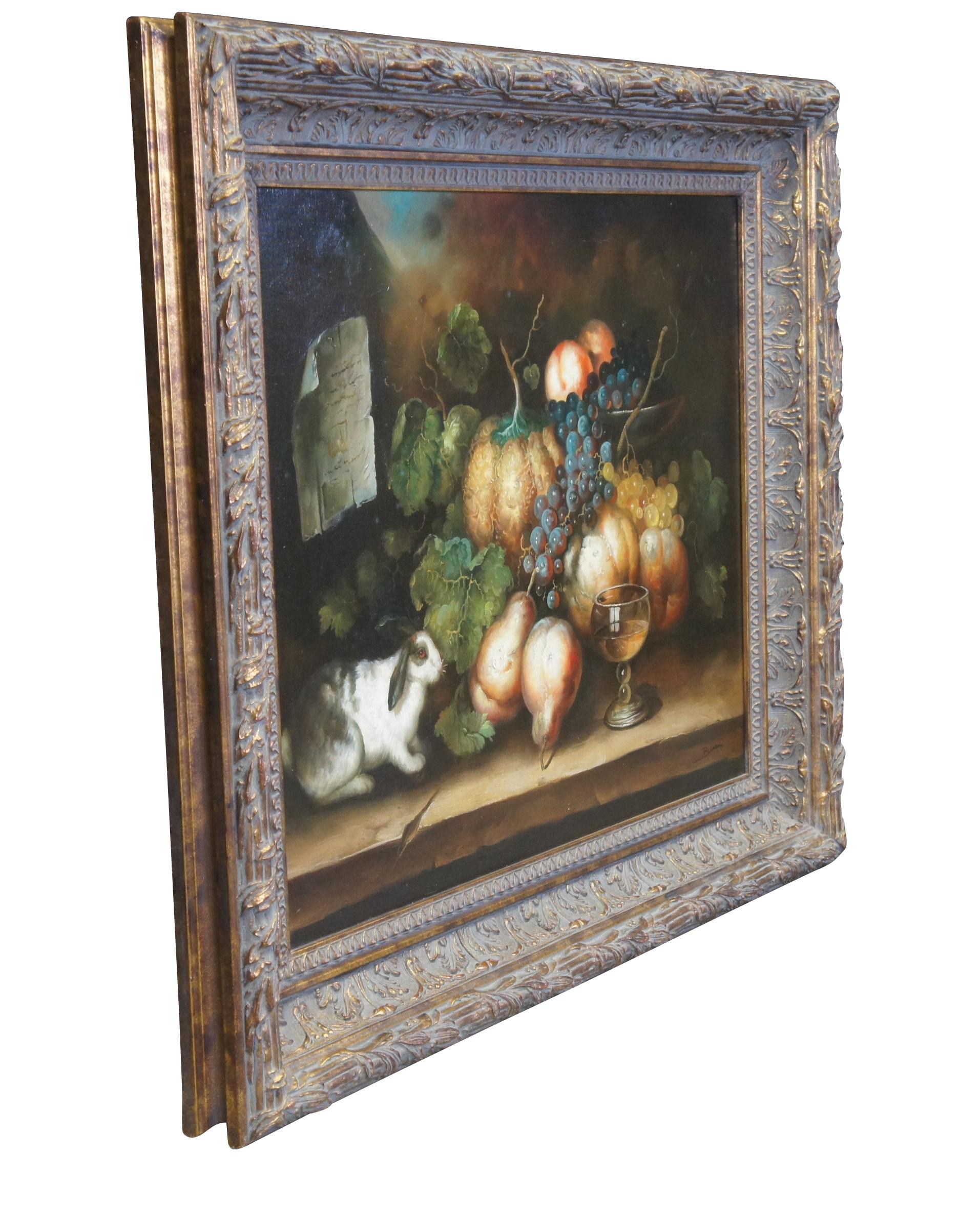 Vintage Bluhm still life oil painting on canvas featuring a bunny / rabbit next to a spread of lettuce, pears, peaches, gords / pumpkin, wine and grapevines on an old farmhouse table.  Signed lower right.  Framed in gold frame with leaves and floral