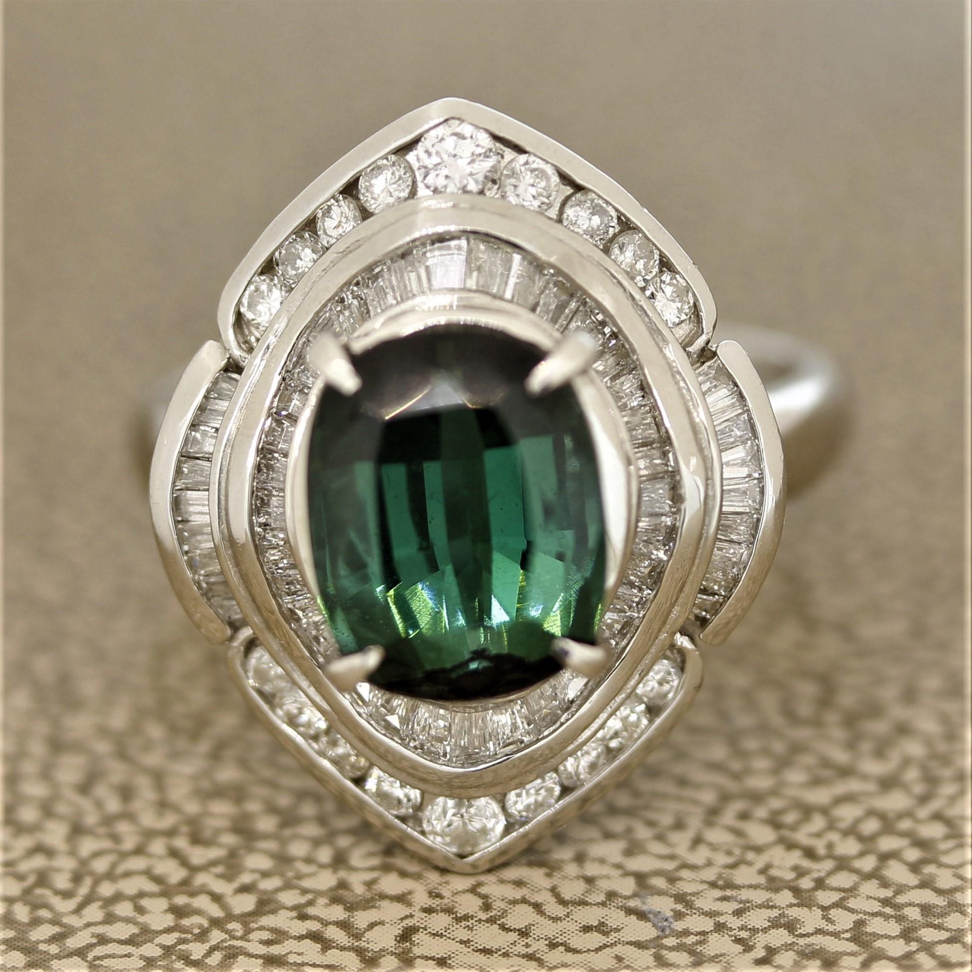 A simple yet elegant tourmaline ring. It features a deeply saturated bluish-green tourmaline in a cushion shape. It weighs 3.47 carats and has a similar color to an indicolite tourmaline but with a green primary color. It is accented by 0.82 carats