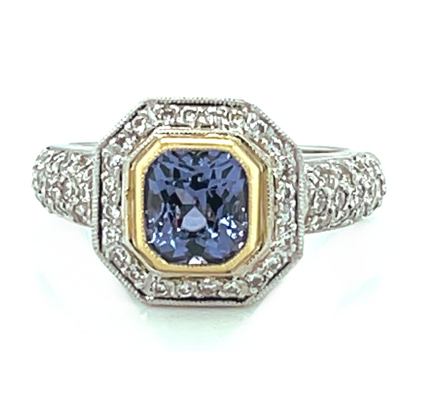 This sparkling, eye-catching ring features a gorgeous 1.54 carat radiant-cut purple spinel surrounded by brilliant white diamonds in a beautifully regal setting! The spinel  is an exceptional gem with bright lavender purple color and rich bluish