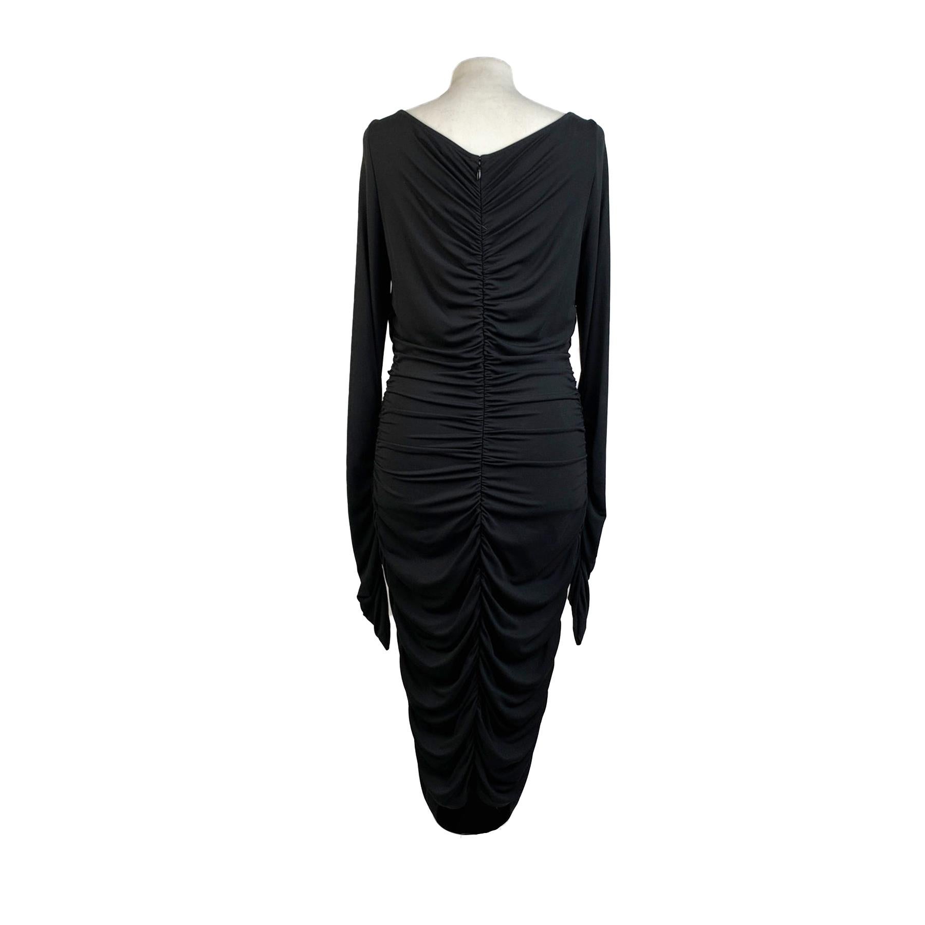 Blumarine Long Sleeve Dress with ruched sides. Crafted in black stretch jersey fabric. It features cut-out detailing on the shoulder, boat neckline and a rear zip closure. Unlined. Composition: 95% rayon, 5% elastan. Size: 44 IT, 38 D (it should