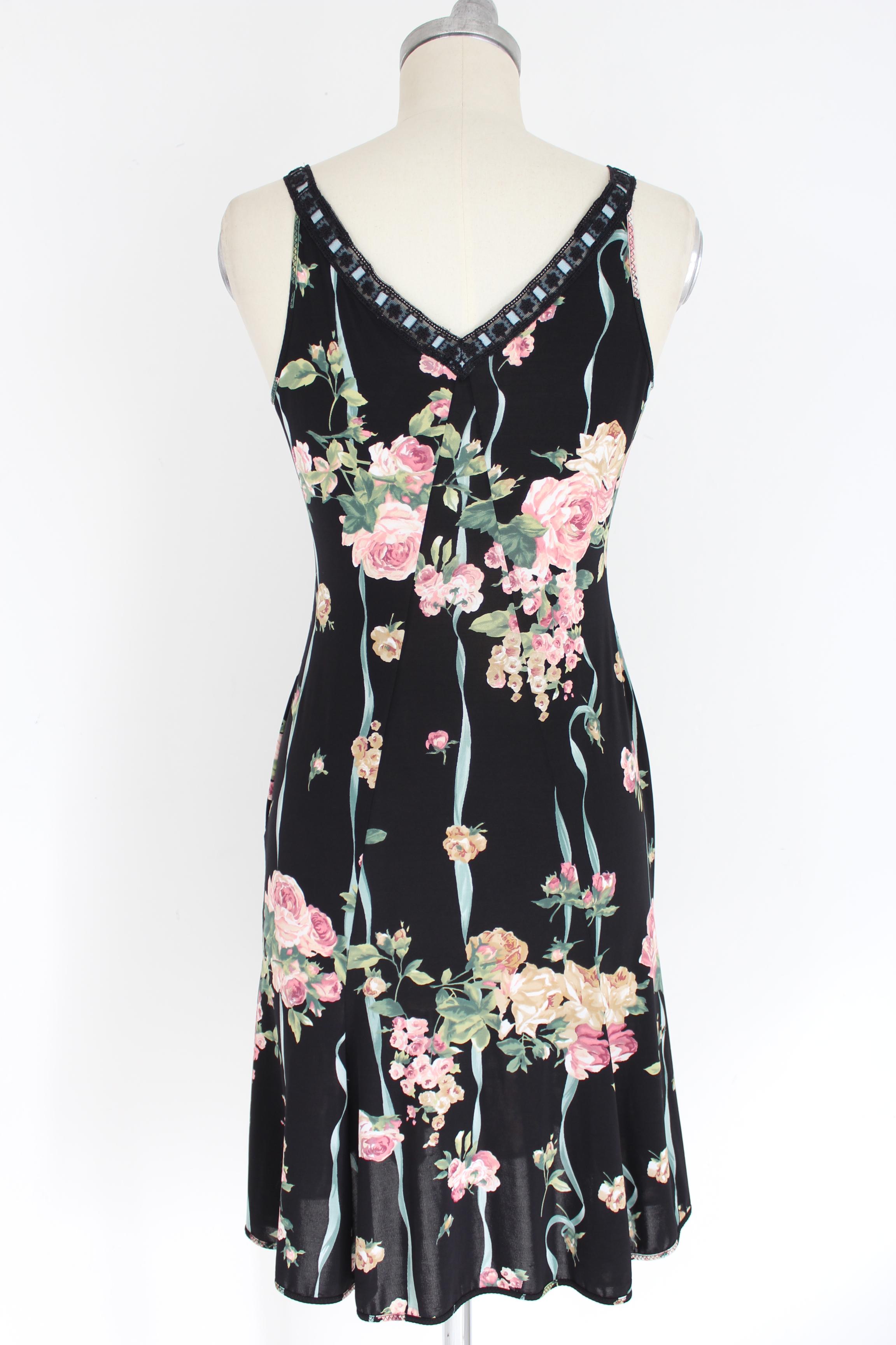Blumarine 90s vintage woman dress. Dress tight at the waist and flared on the length, sleeveless, V-neck. Black and pink color with floral designs. 90% polyamide 10% spandex. Made in Italy. Excellent vintage condition.

Size: 46 It 12 Us 14