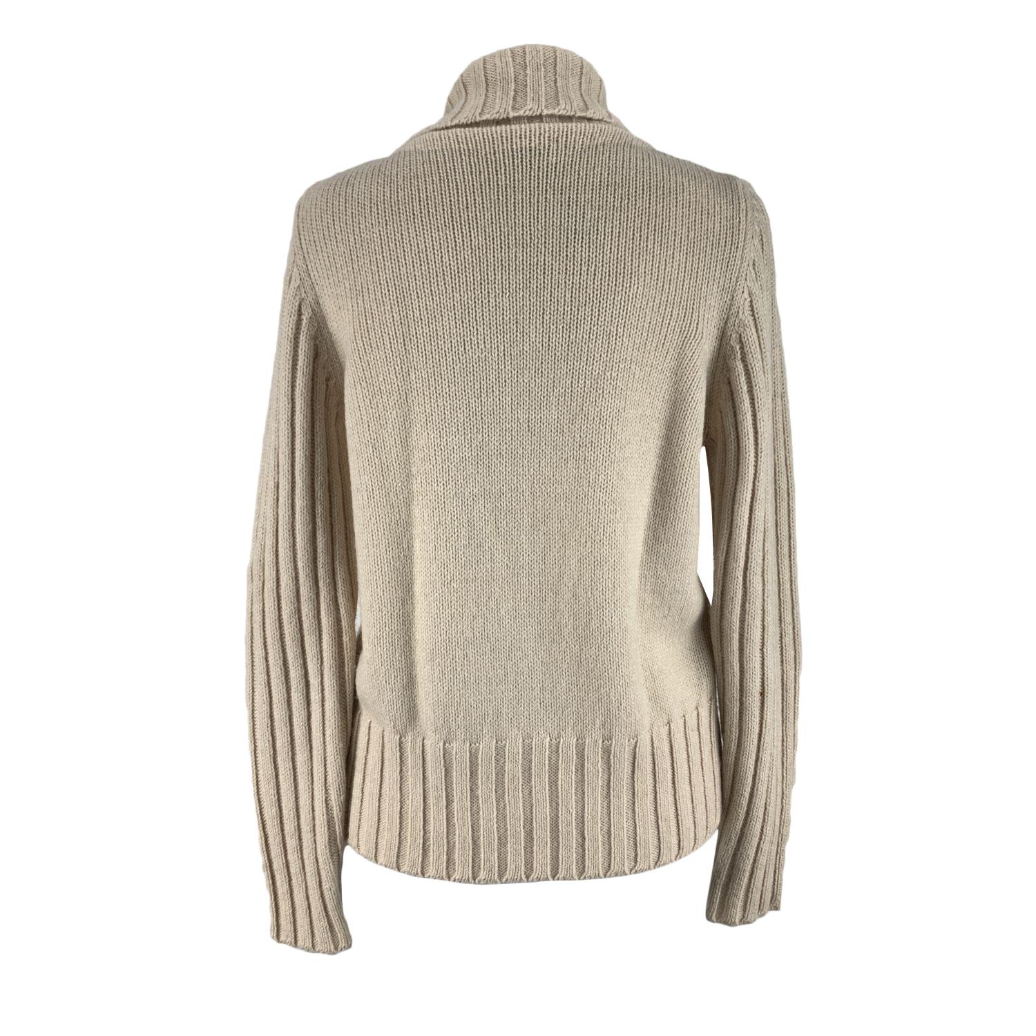 Blumarine Blugirl beige cardigan with floral applique with sequin on the shoulder. It features ribbed collar, sleeves and hem. Hook and eye closure on the front.Composition: 42% wool, 30% acrylic, 28% alpaca. Size: 46 IT, 40 D (The size shown for