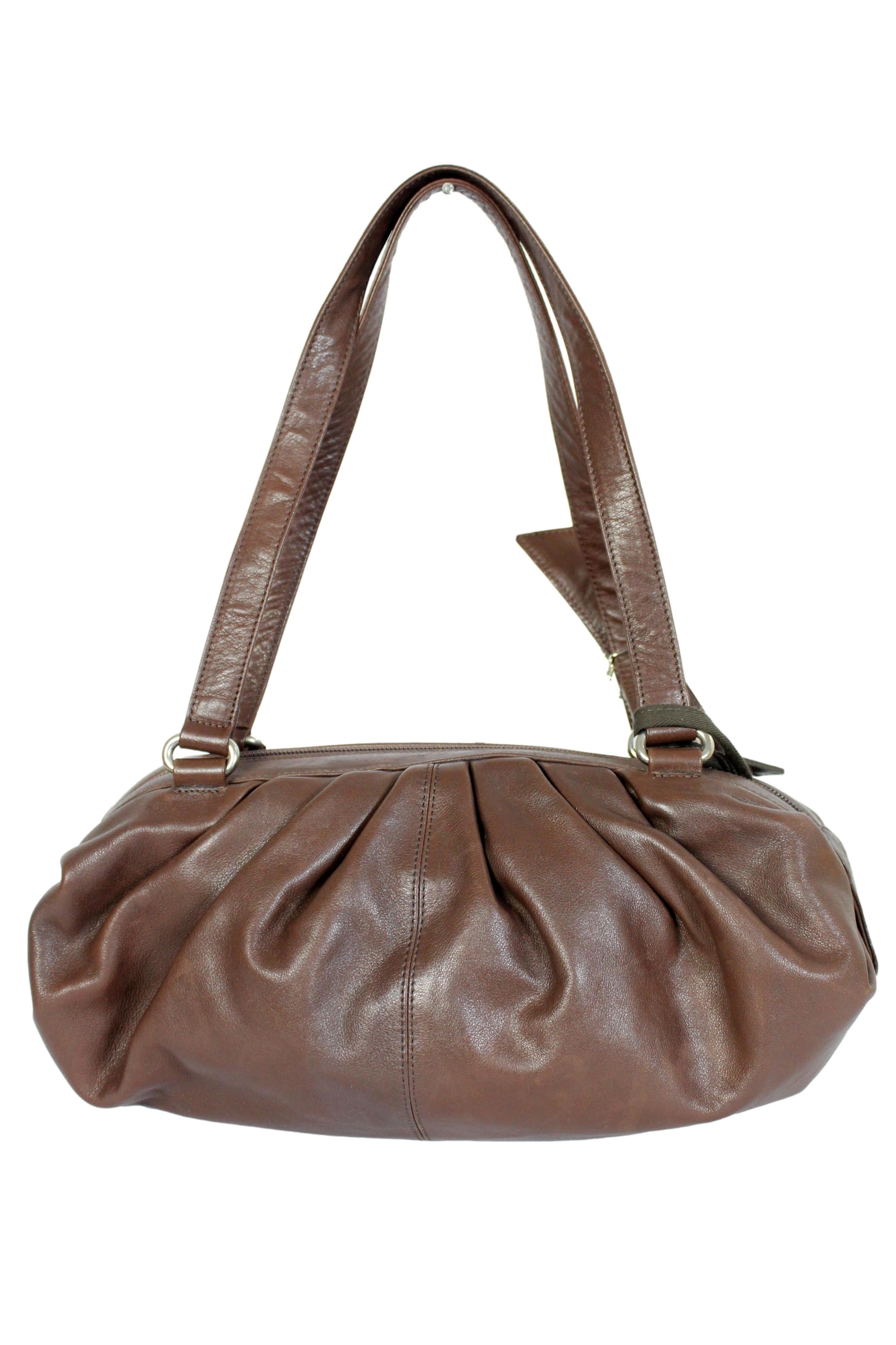 Blumarine 2000s shoulder bag. Soft satchel model bag, brown, leather. Zip closure, rhinestone logo on the shoulder strap. Made in Italy.

Condition: Excellent

Item used few times, it remains in its excellent condition. There are no visible signs of