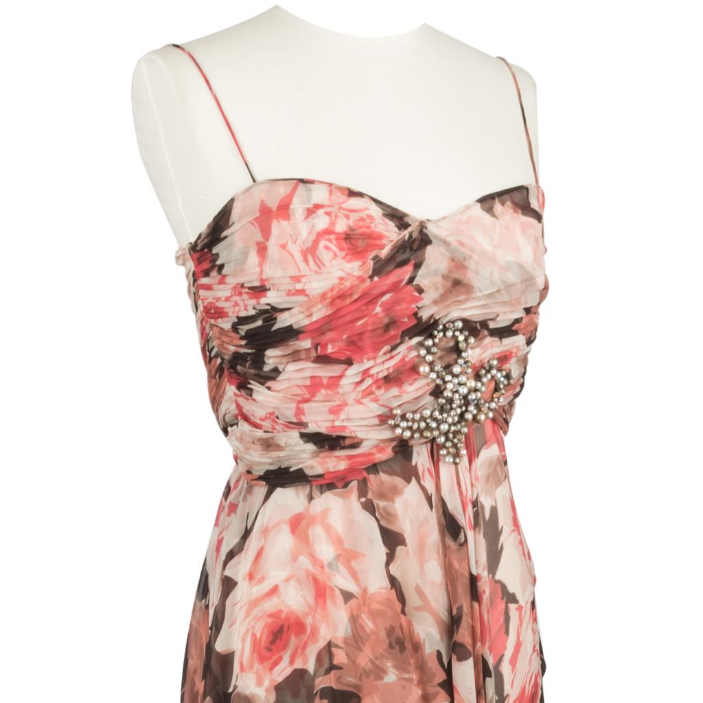 Guaranteed authentic Blumarine dress features an exquisite profusion of roses in the pales shade of pink, with deepening shades to a creamy rose.  
Accentuated with rich brown - the effect is chic.
The top of the dress has small, soft pleating in a