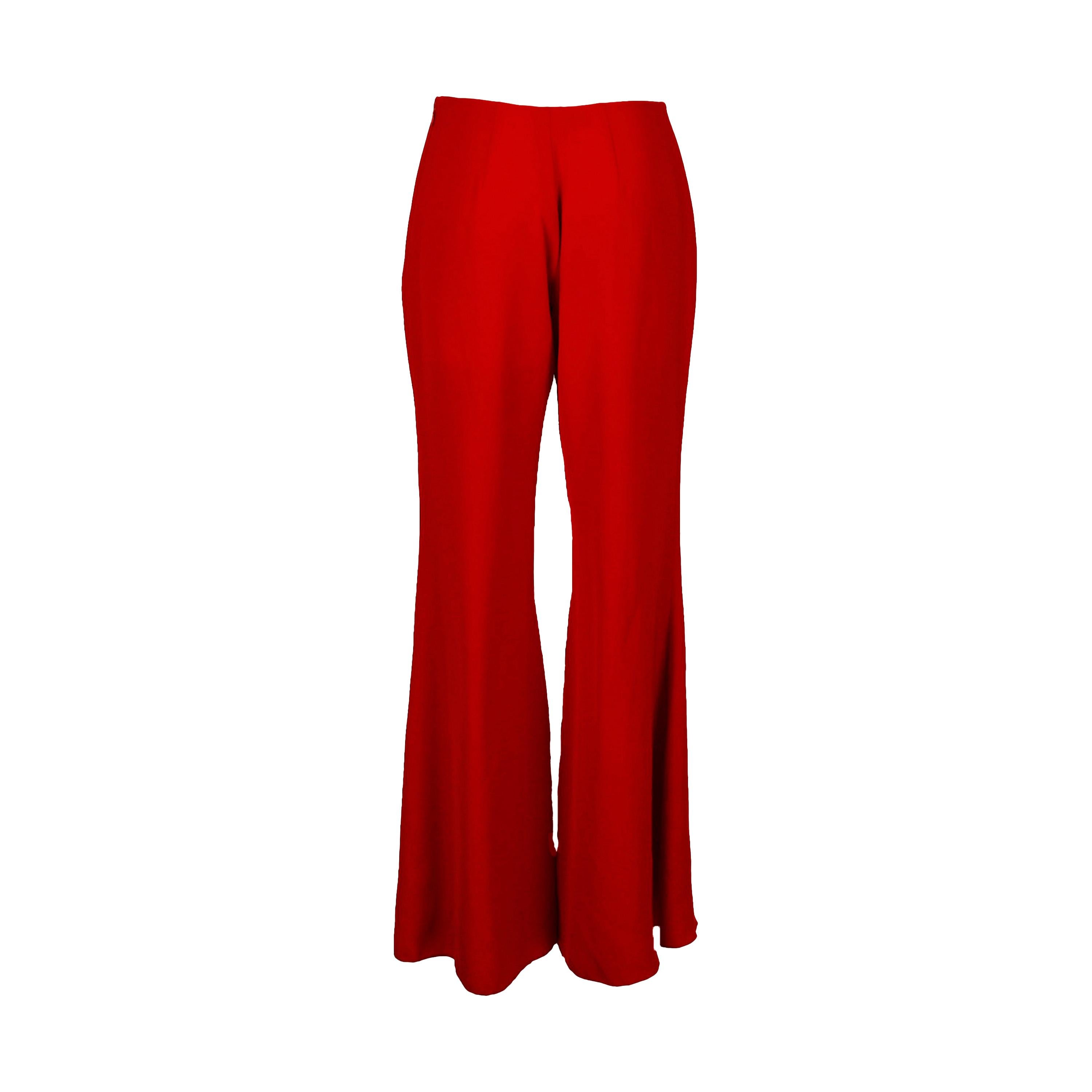 These chic Blumarine flared trousers make a statement with its bold red color, featuring a flared silhouette with a chic ruffled slit on the front, revealing a lightweight leopard print panel. A side zipper ensures a comfortable fit.

Remarks: There