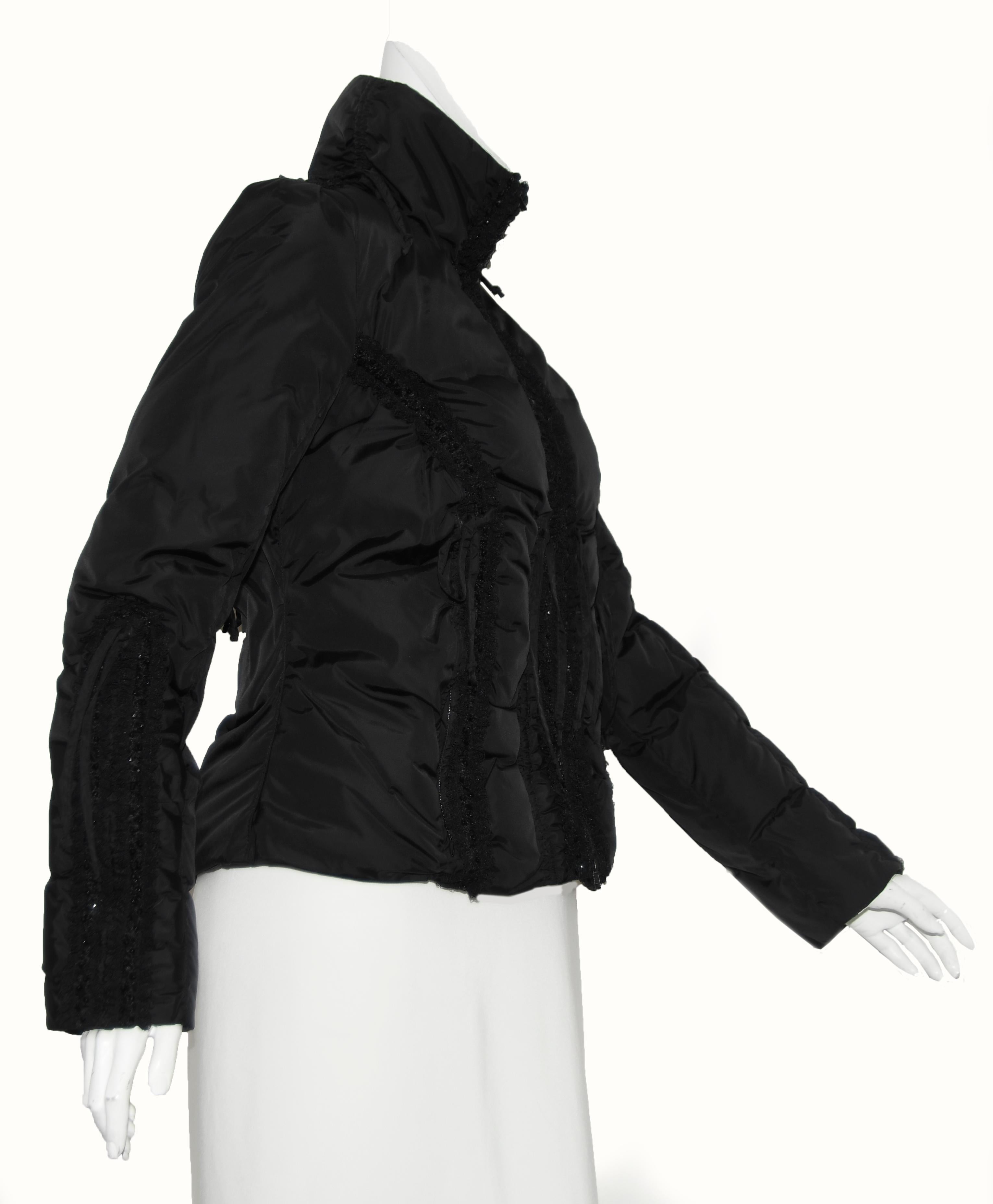 Blumarine black goose down puffer jacket is decorated with lace and beads.  This ultra feminine looking jacket is very strong and will keep you warm!  The lace and bead trim can be found on the sleeves, the zipper opening and one strip on each side