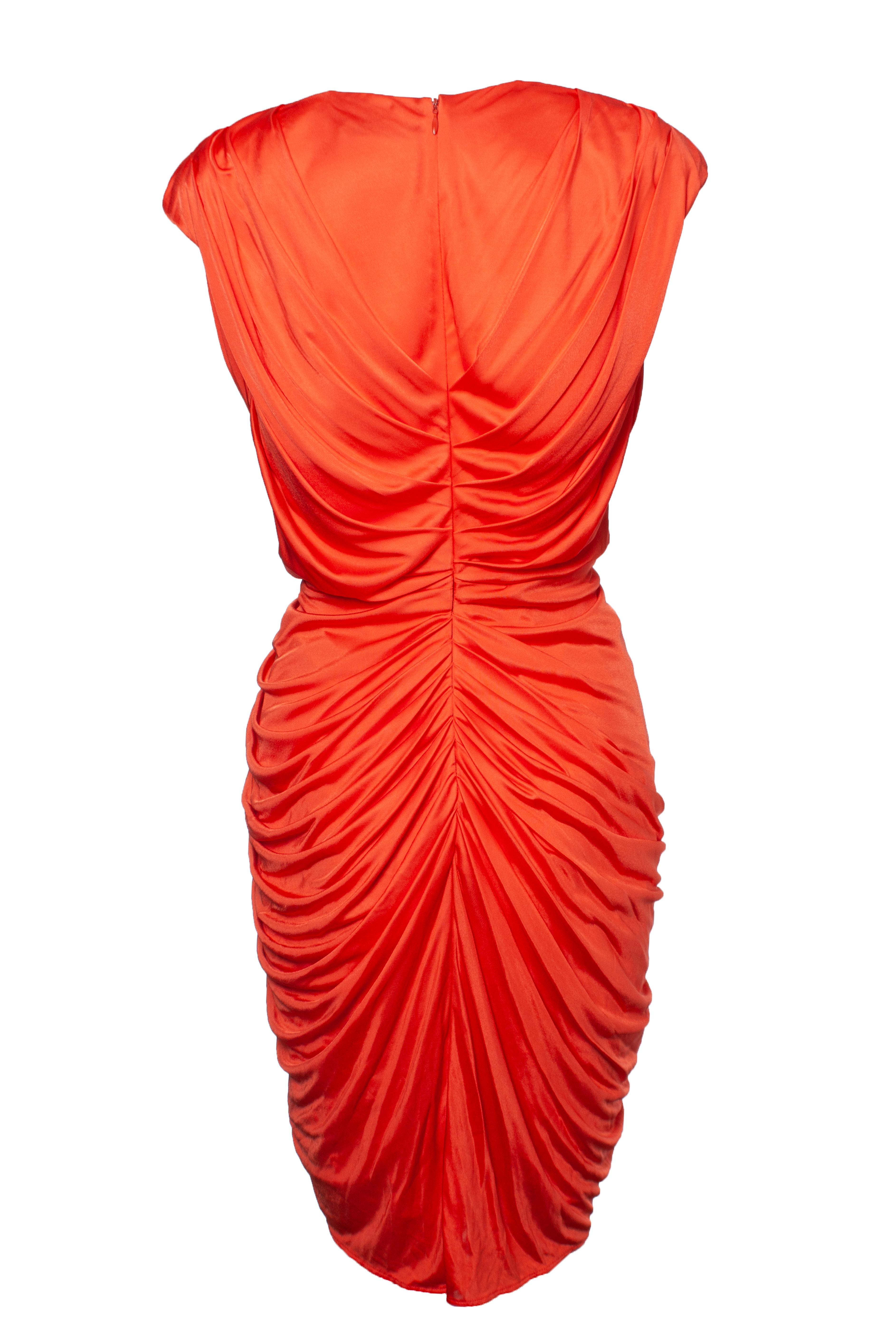 Blumarine, Orange draped dress with crystal embellishments. The item is in very good condition. Dress has shoulderpads.

• CONDITION: very good condition 

• SIZE: IT44 - M 

• MEASUREMENTS: length 97 cm, width 41 cm, waist 34 cm

• MATERIAL: 100%