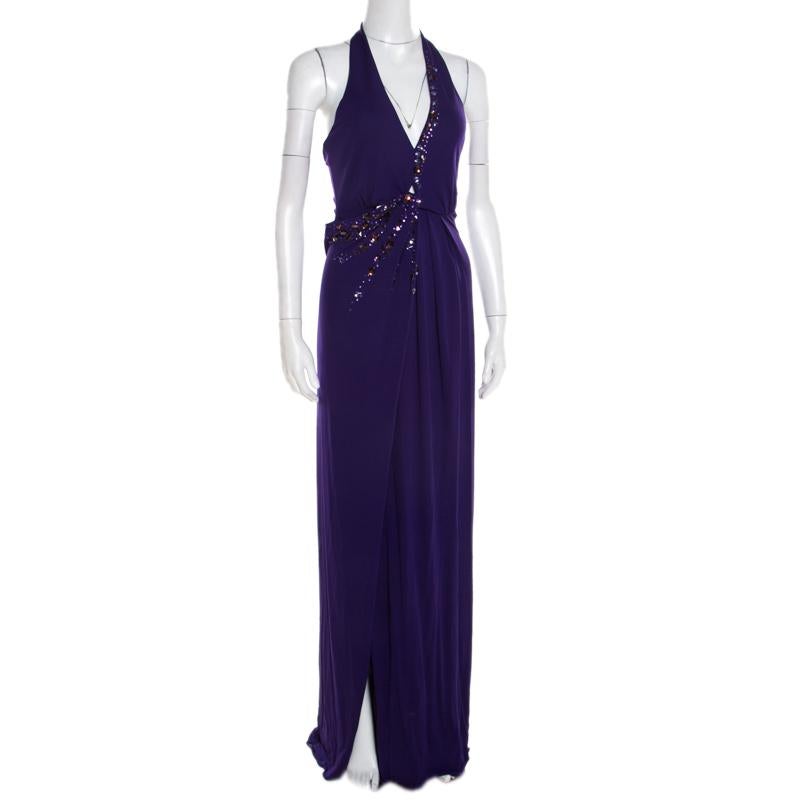 Let eyes be on you when you step out in this gorgeous gown from Blumarine! The purple creation is made of a viscose blend and features a draped silhouette. It flaunts exquisite crystal and sequin embellishments on the front and comes equipped with a