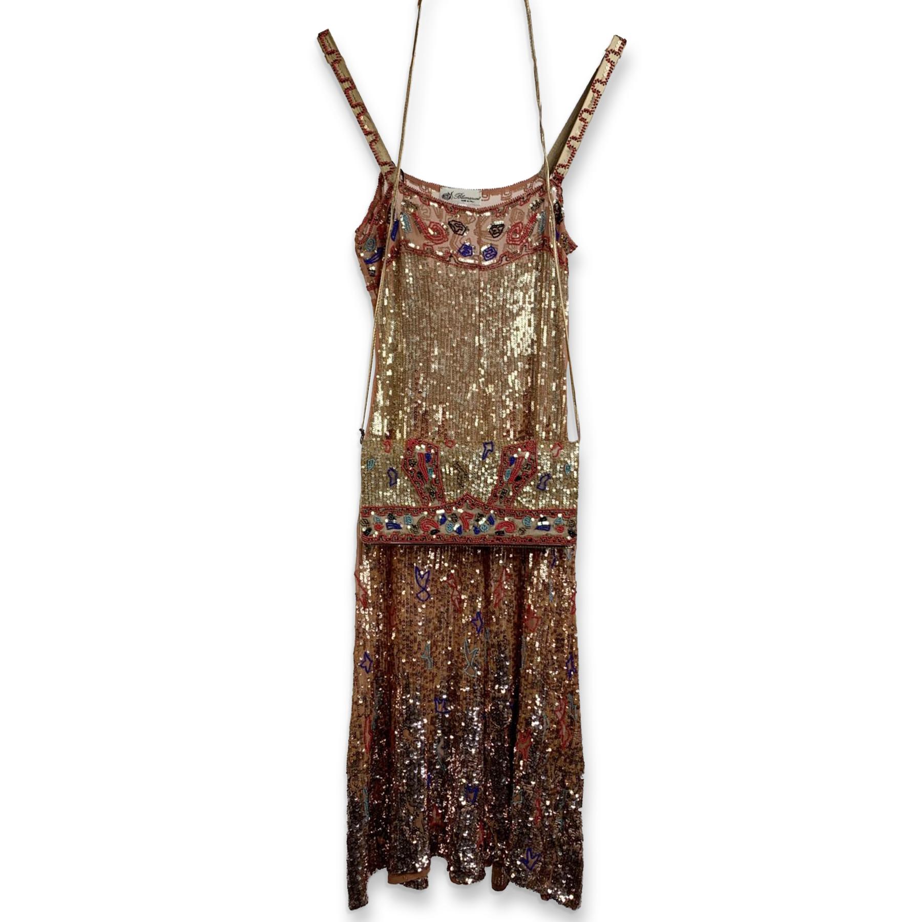 BLUMARINE embellished sleeveless dress. Made in Italy. Scoop neckline. Mesh with all over rhinestones and beads embellishment detailing. Side button placket. The fabric is semi-sheer. It comes with its matching embellished bag. Size: 40 IT, 34 D (it