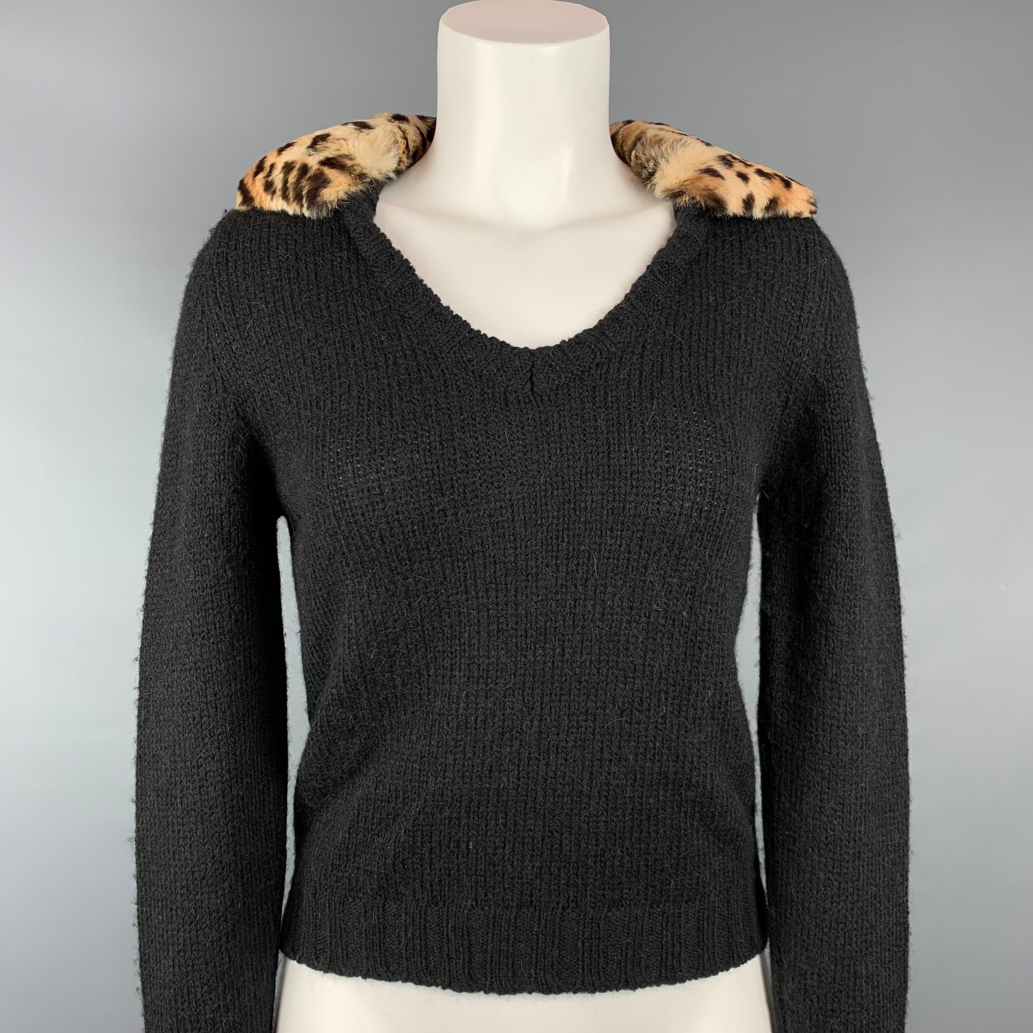 BLUMARINE pullover comes in black knitted wool blend featuring a fur trim and v-neck. Made in Italy.

Very Good Pre-Owned Condition.
Marked: I 40 / D 34 

Measurements:

Shoulder: 14 in.
Bust: 34 in.
Sleeve: 29.5 in.
Length: 21 in. 
