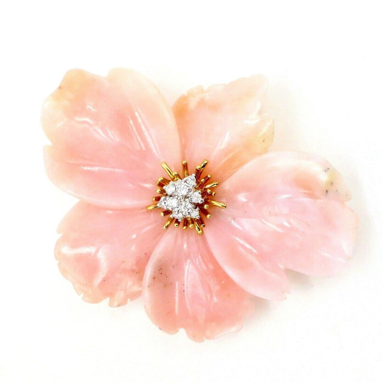 Estate, beautifully hand made Coral and Diamond Flower brooch in 18K yellow gold.

This meticulously crafted brooch and pendant is design as a hand carved in blush pink coral five petals flower, centered with 9 round brilliant cut diamonds in subtly