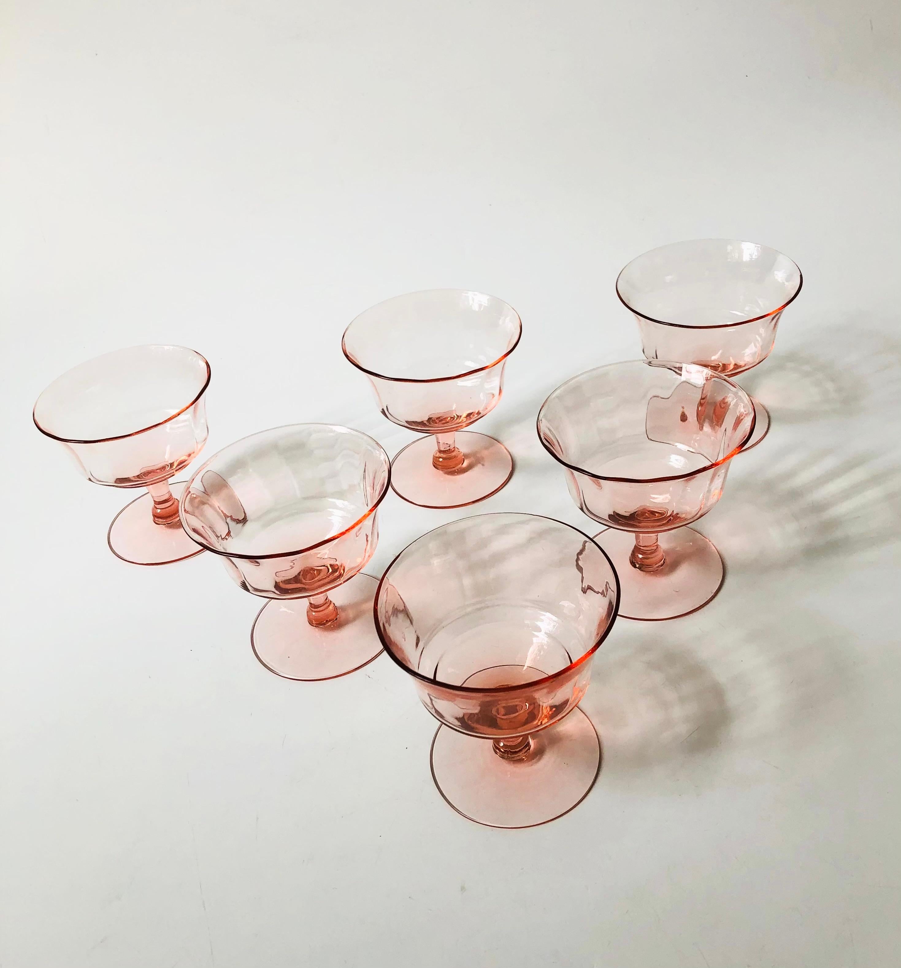 A set of 6 vintage coupe glasses in a pale blush pink hue. Made of delicate thin glass with a lovely light texture. Perfect for champagne or wine.

