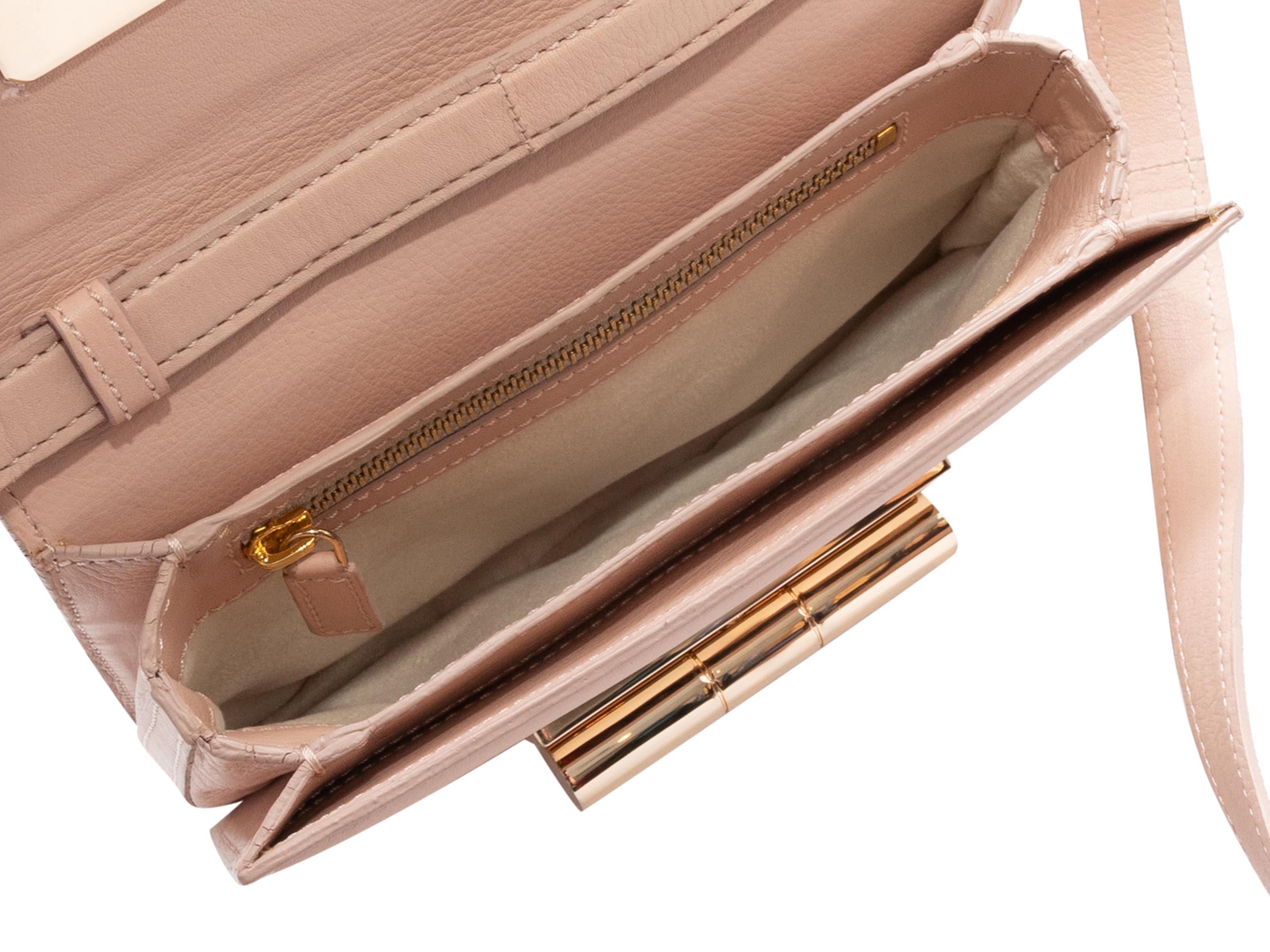 Blush Tom Ford Natalia Crossbody Bag. The Natalia Crossbody Bag features a leather body, gold-tone hardware, a single flat crossbody strap, and an oversized front turn-lock closure. 8.2