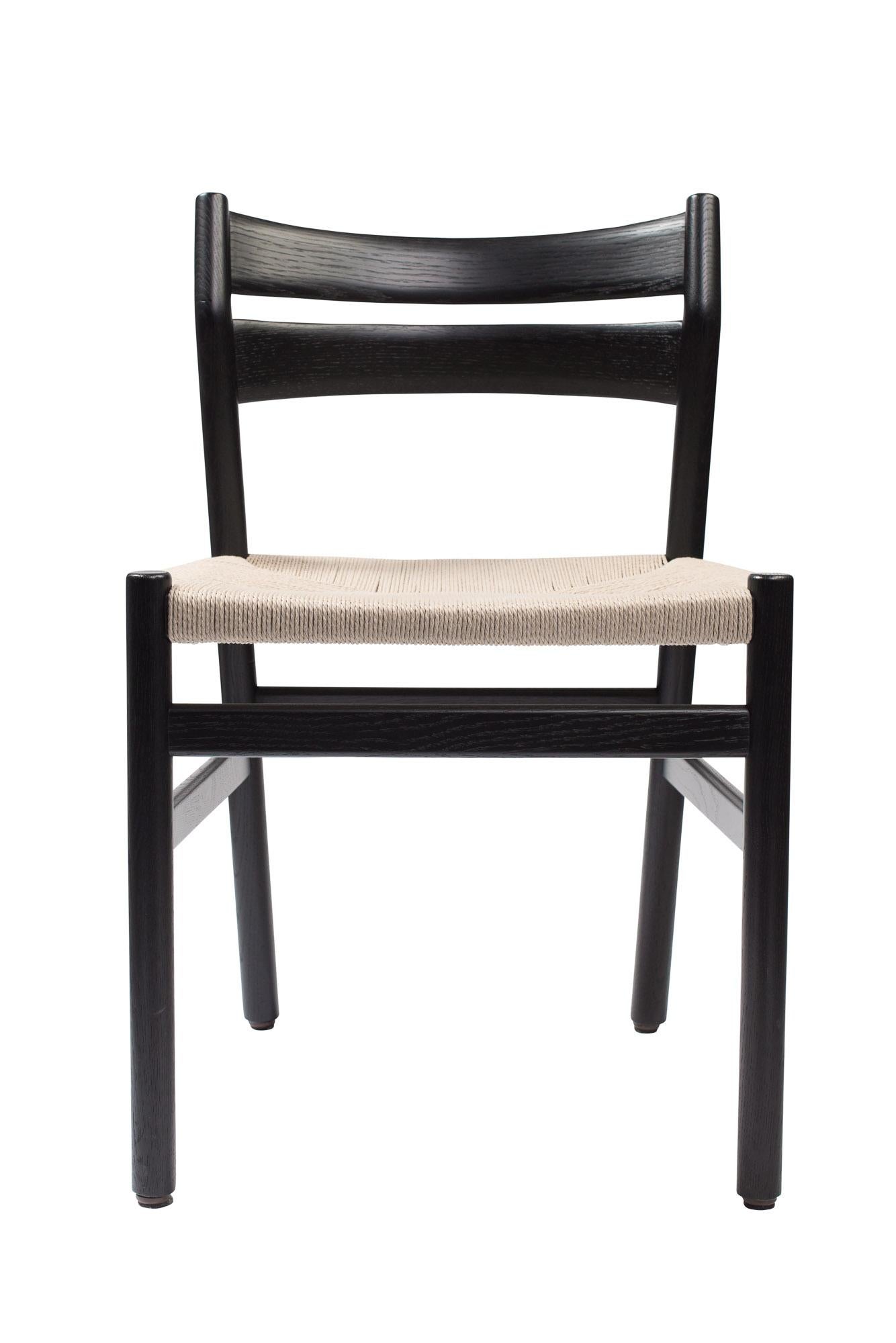 BMI chair
Solid oak frame, paper cordel seat
Dimensions : H78 x 44 x 51 cm (seat height 46cm)

Wood:
– Oak
– Smoked oak
– Black lacquered oak

Paper cordel:
– Natural
– Black

 
The collection of chairs BM1 and BM2, signed by DK3, was