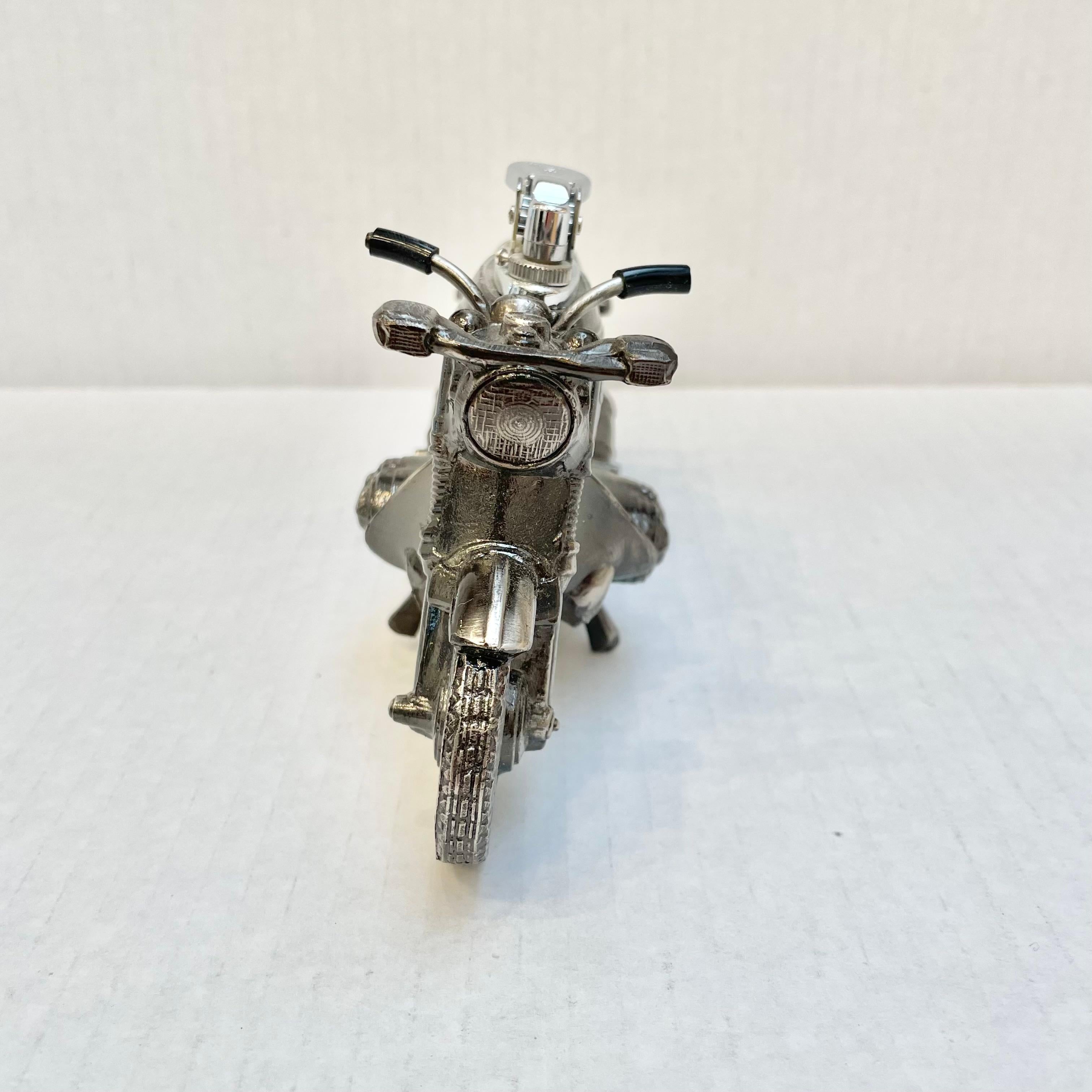 Cool vintage table lighter in the shape of a BMW cafe racer motorcycle. Made completely of metal with a hollow body. Beautiful burnished silver color with intricate details. Cool tobacco accessory and conversation piece. Working lighter. Very