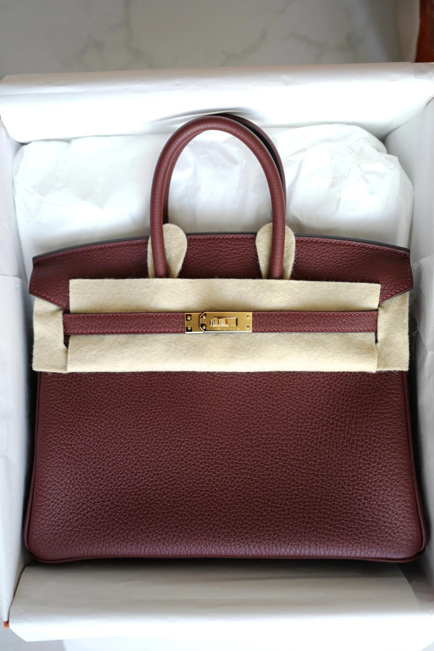 The Hermès Birkin 25 in Rouge H Togo Leather with Gold Hardware is the epitome of timeless luxury and sophistication. This bag offers a classic yet contemporary appeal, making it one of the most coveted styles in the Hermès lineup. Here's a detailed