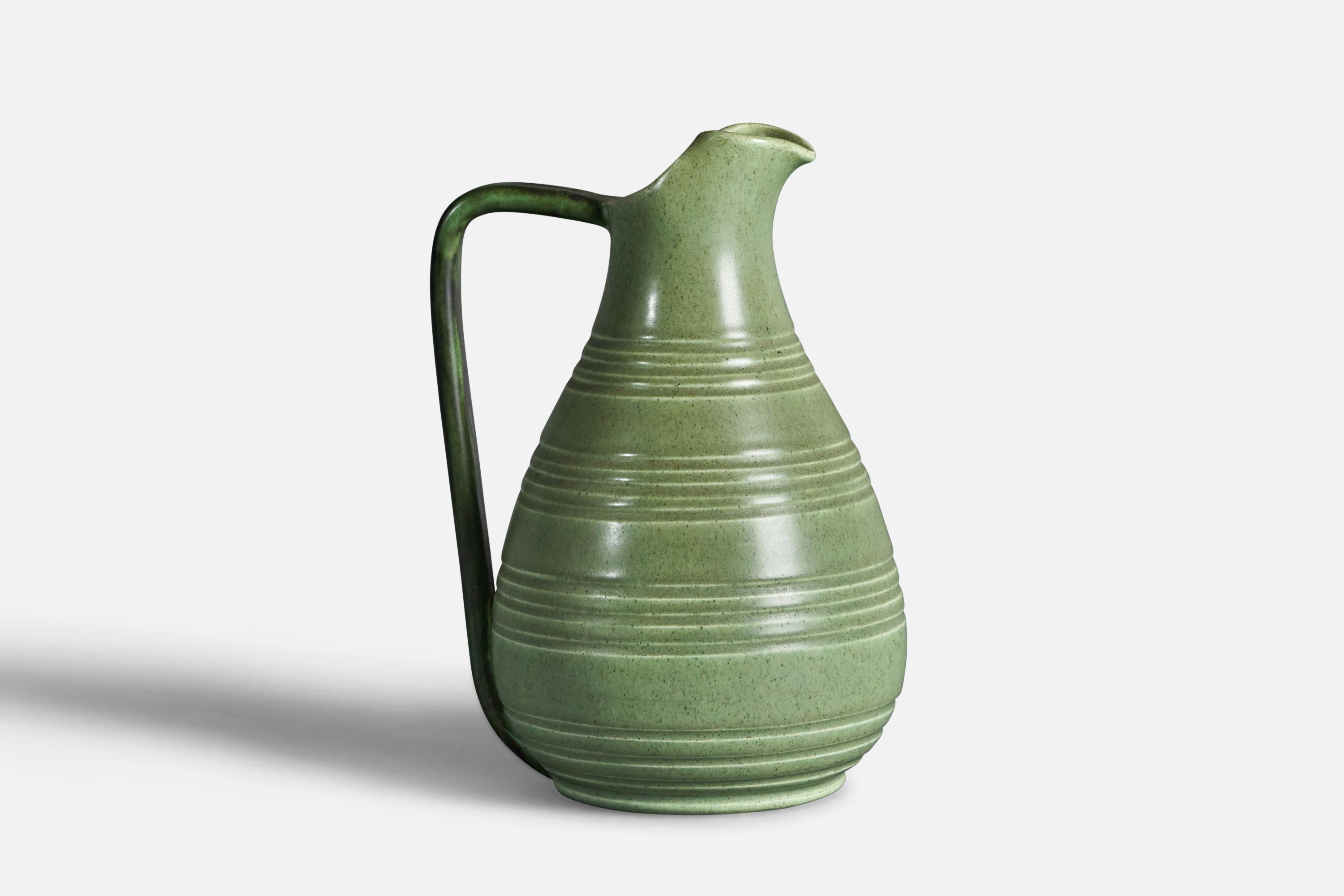 A green-glazed and incised pitcher designed and produced by Bo Fajans, Sweden, c. 1940s.