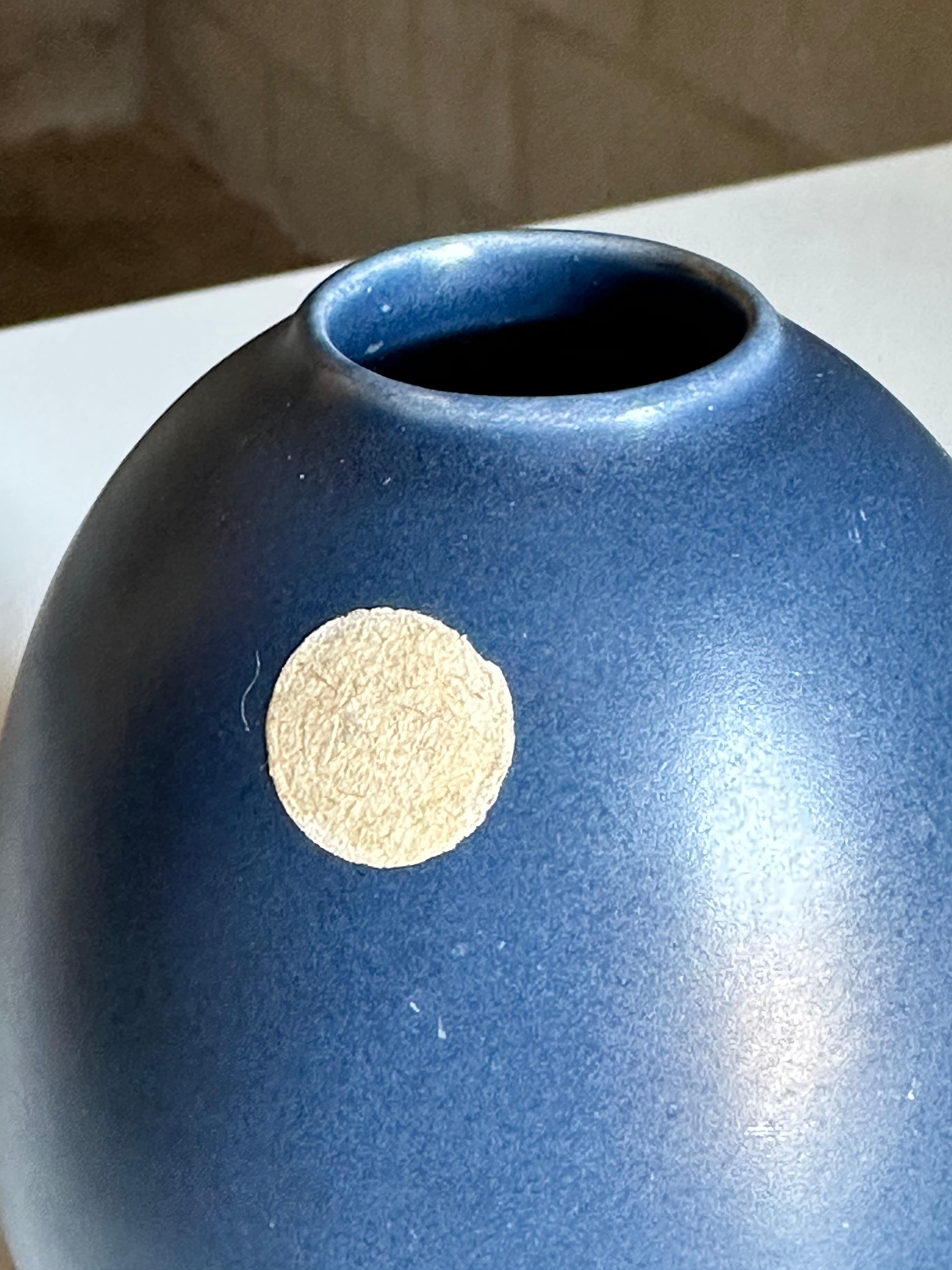 Wonderful vase in a vibrant blue manufactured by Bo Fajans. Great bulbous rounded form and striking color. This vase retains its original sticker on the outside, albeit now faded. Vase is also signed on bottom. 
