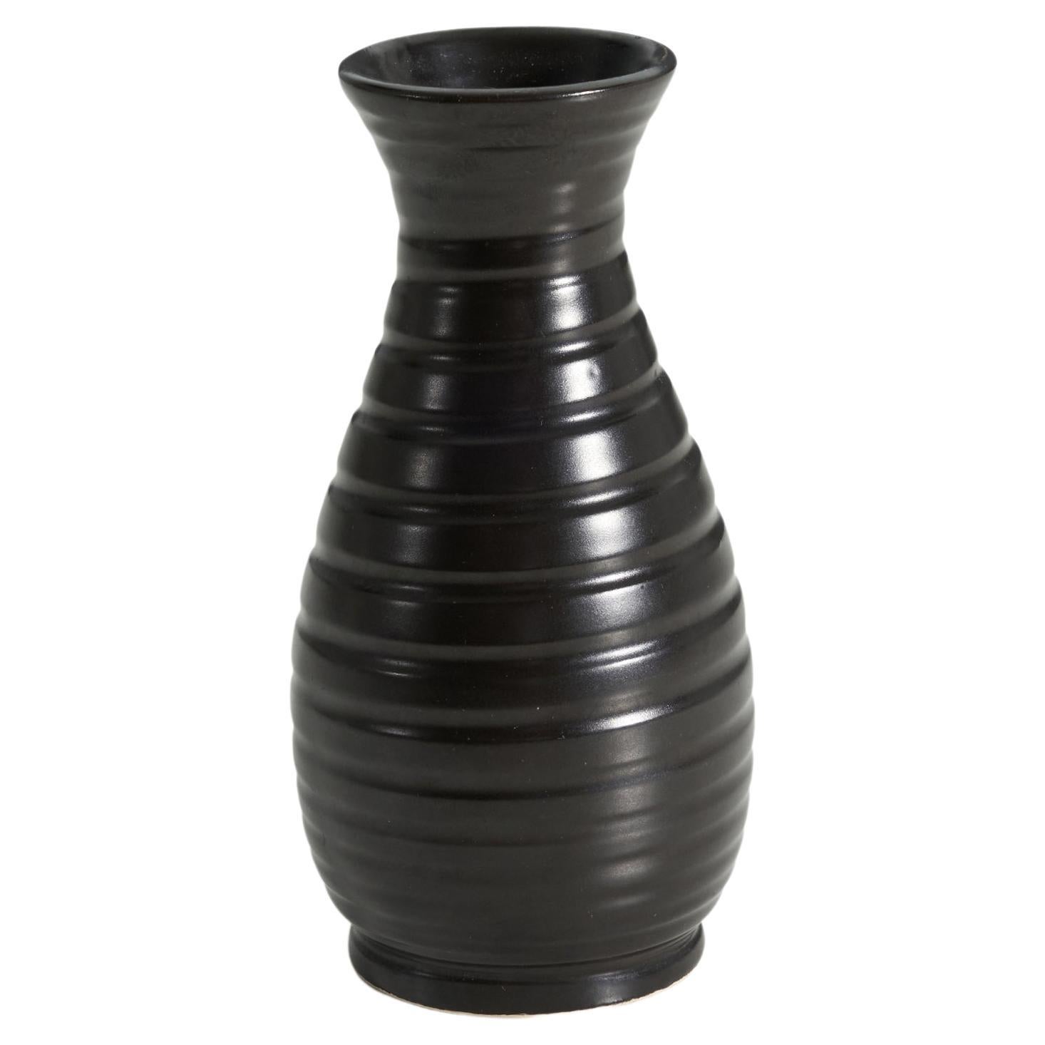 A black-glazed earthenware vase produced by Bo Fajans, Sweden, c. 1940s. Marked on base. 

.