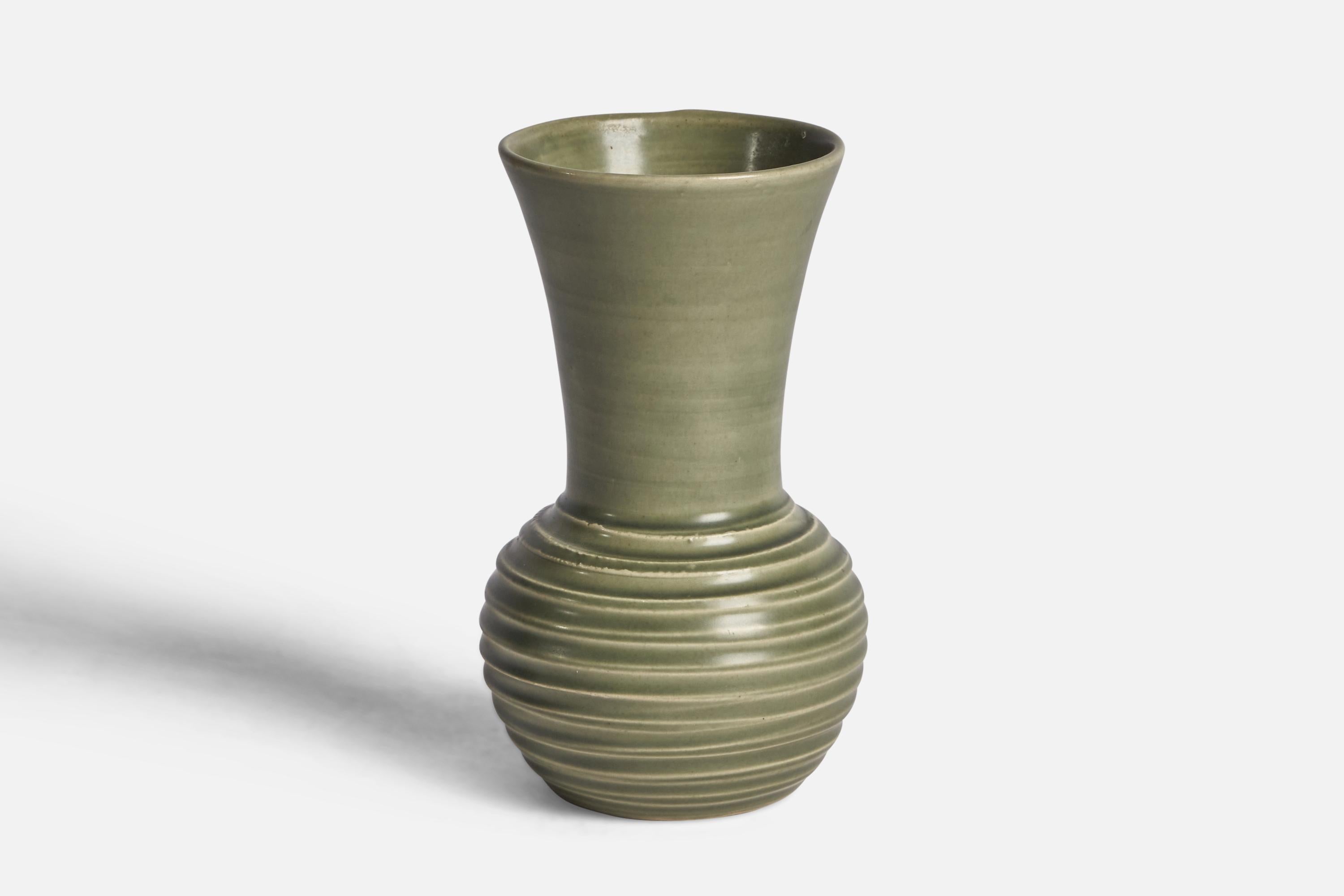 A green-glazed earthenware vase designed and produced by Bo Fajans, Sweden, 1940s.

“FAJAN SWEDEN 1797” on bottom 
