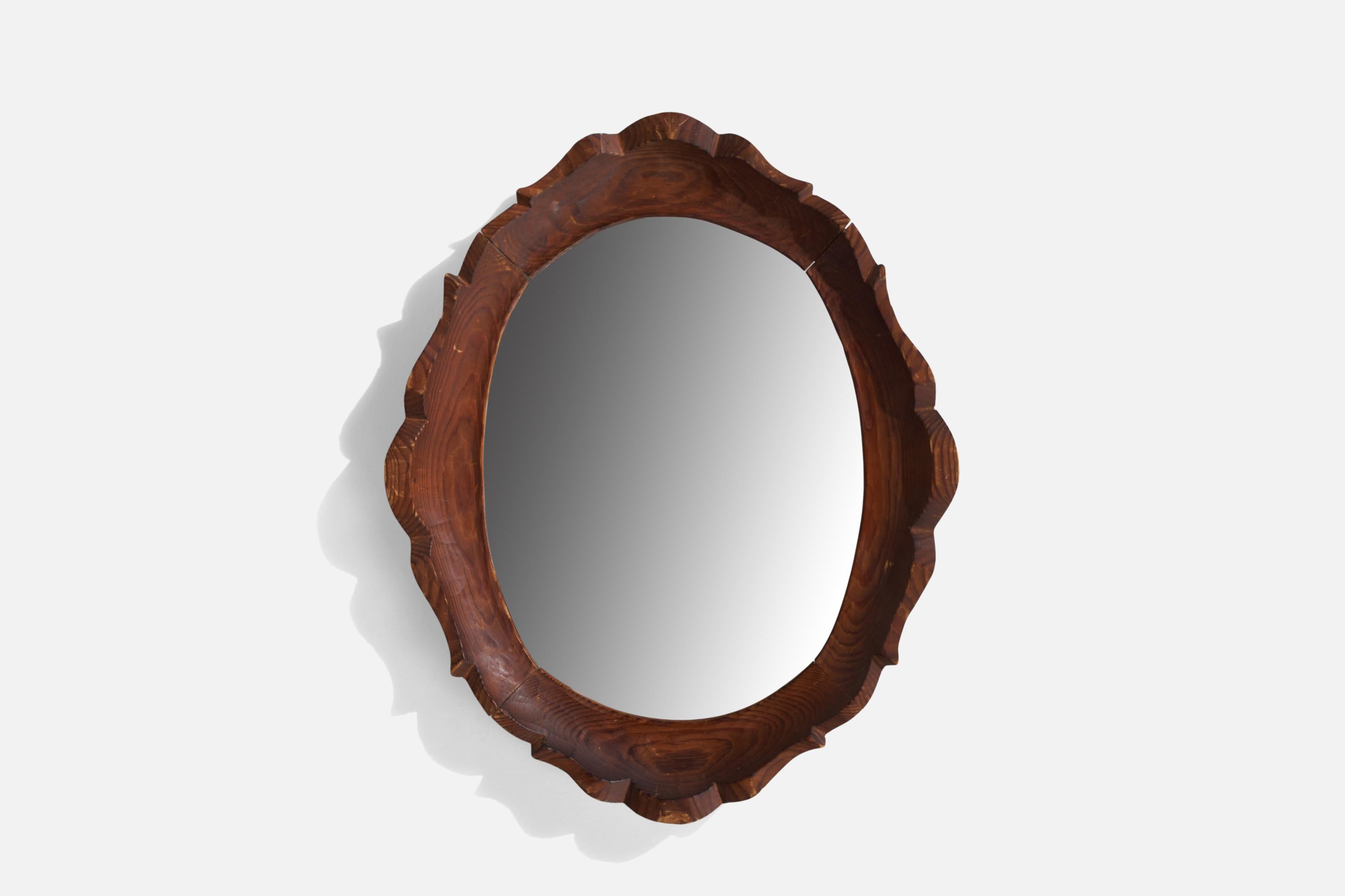 A carved pine wall mirror designed and produced by Bo Fjæstad, Arvika, Sweden, c. 1930s.