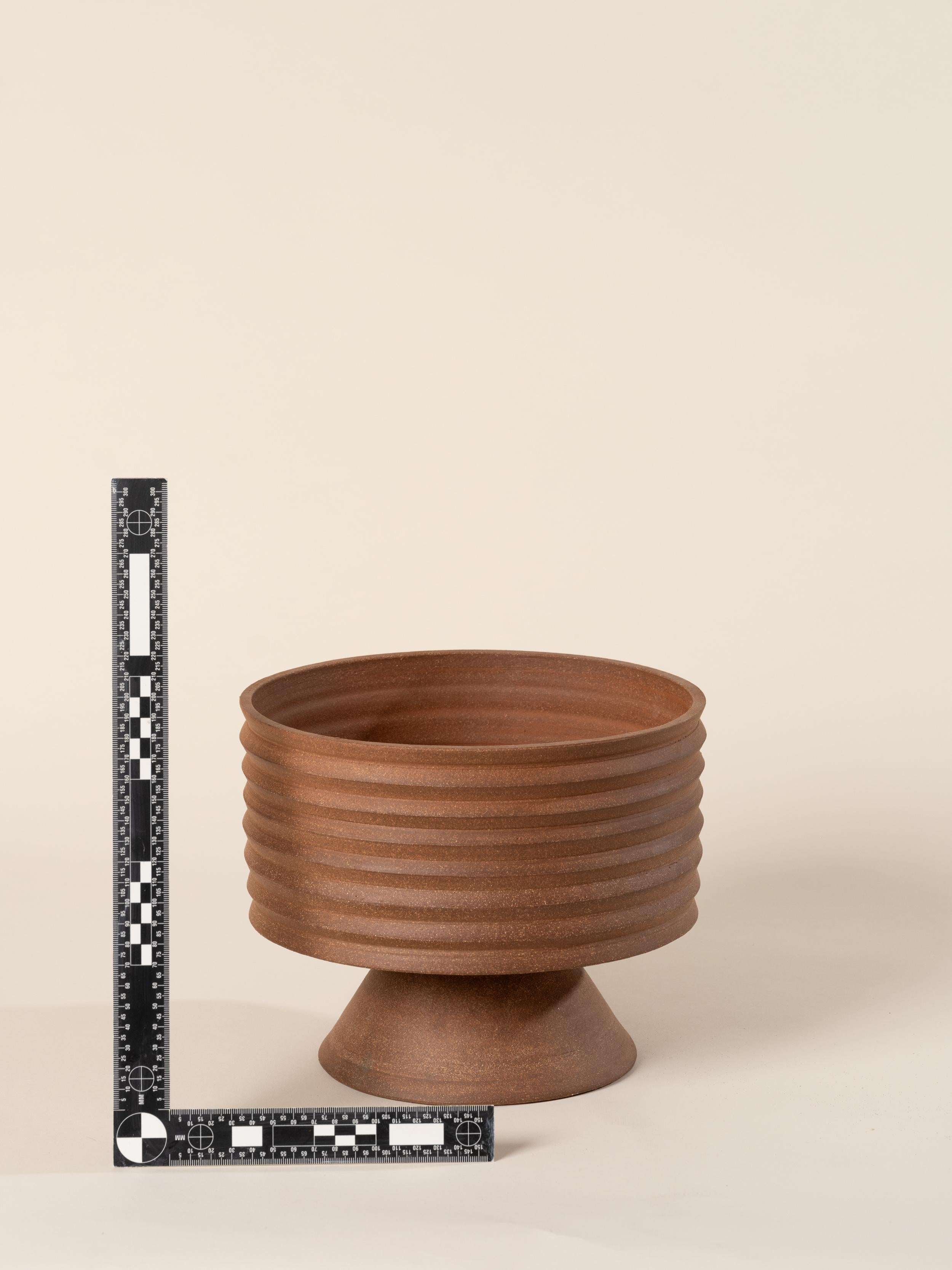 2-part wheel-thrown planter in red stoneware.

Dimensions: approx. 8” h x 9.5” w

The upper part features a drainage hole for optimal plant health, and the bottom part collects excess water – make sure to empty it periodically.