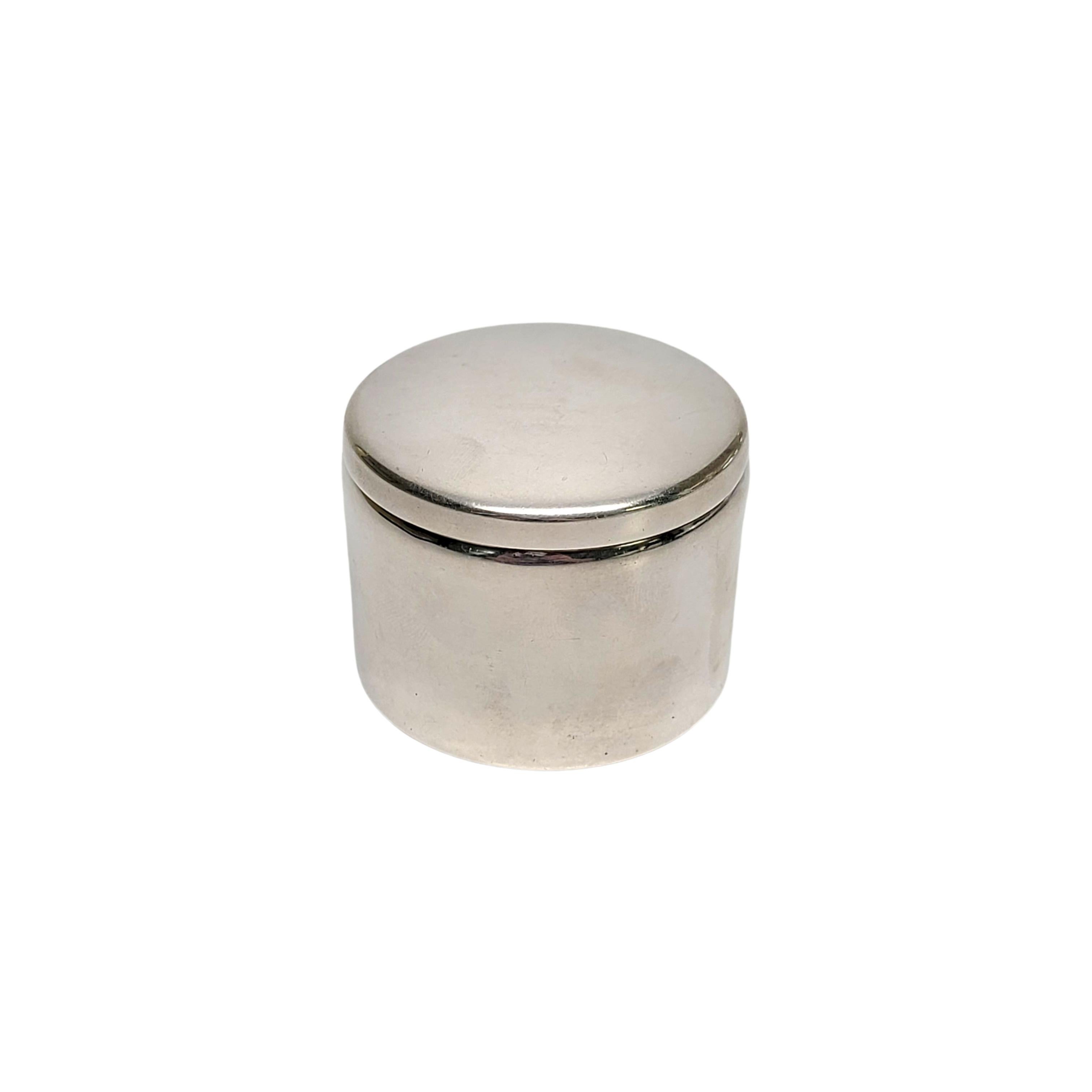 Sterling silver round box for dispensing postage stamps by Boardman.

No monogram

A small round box with a lid, stamps can be dispensed from a roll thru the vertical slot in the side of the box.

Measures 2