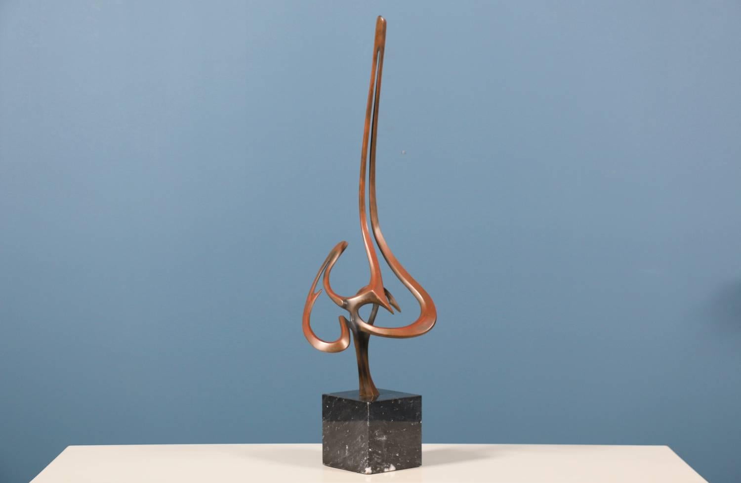 Mid Century modern sculpture designed by Bob and Tom Bennett and manufactured by Bob Bennett in the United States circa 1980’s. This abstract design features a tall bronze body with sharp and pointed edges on a marble base. The sculpture shows a