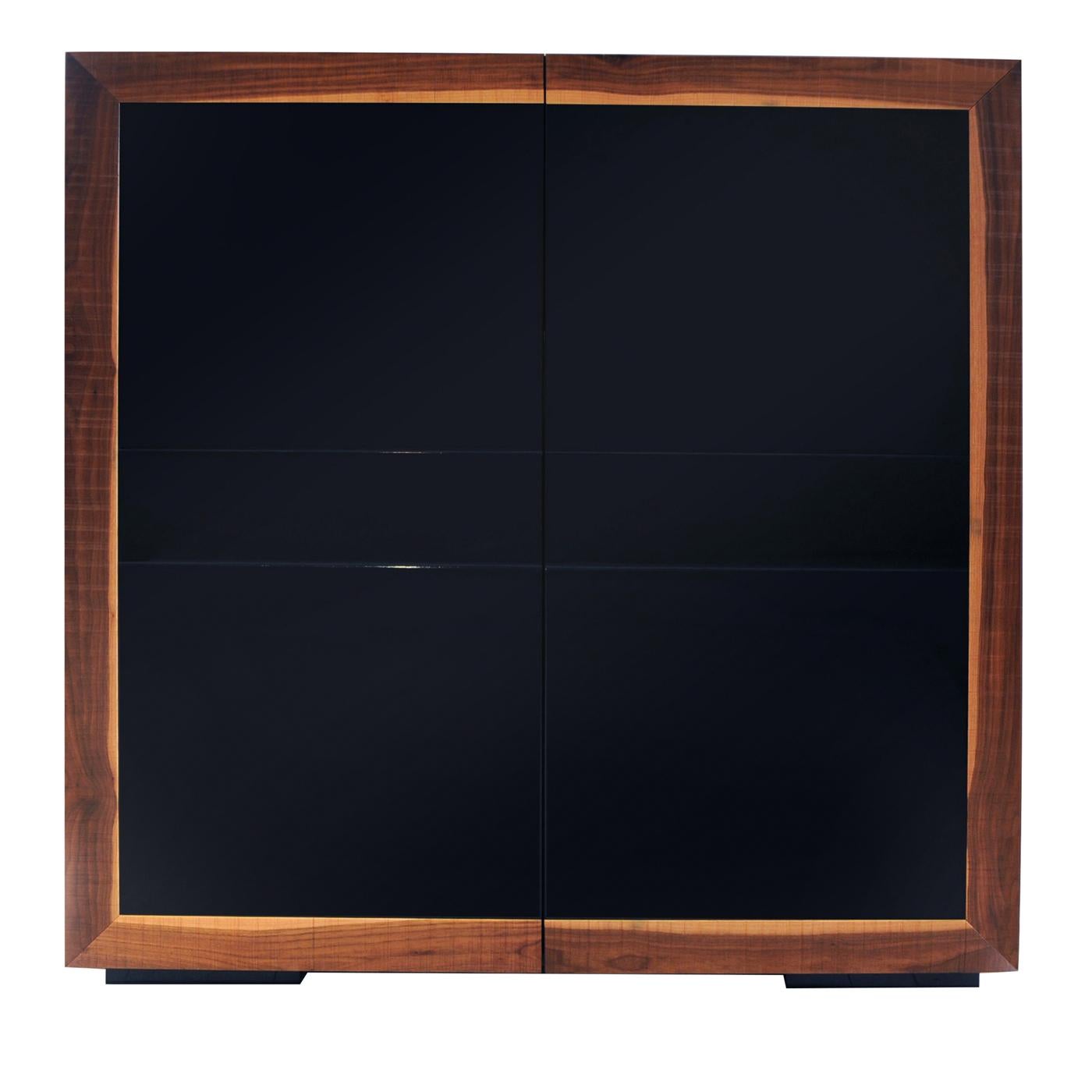 Superbly crafted with a sleek and functional silhouette, this cabinet boasts an elegant design in which the refined materials merge in perfect harmony. It is fashioned of solid Canaletto walnut, visible on the squared edges of the piece and the