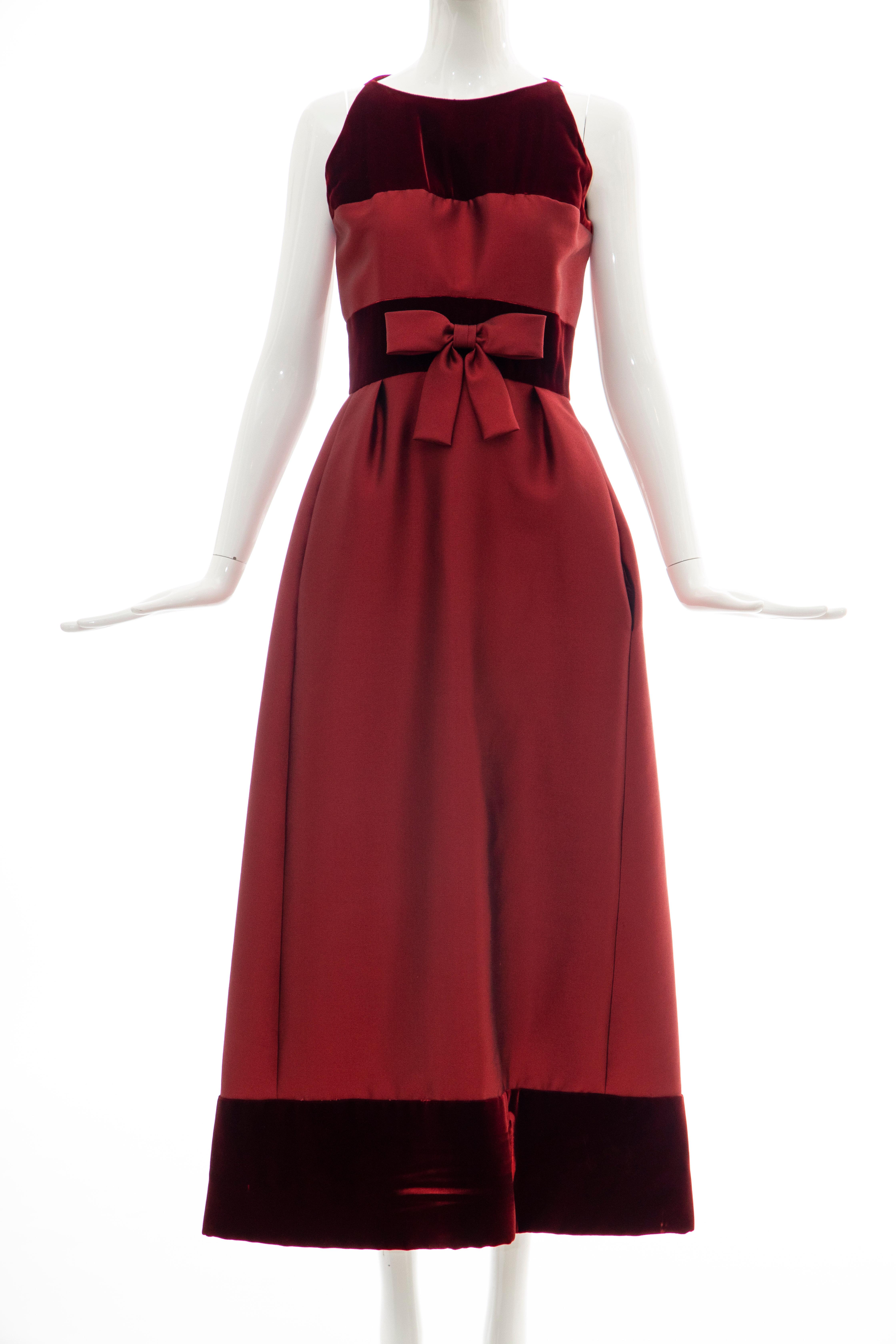 Bob Bugnand, Circa: 1960's cranberry silk gazar and silk velvet sleeveless evening dress, empire waist with silk gazar bow, two front pockets, back zip with hook and eye closure.

No Size Label:

Bust: 31, Waist: 26, Hips: 45, Length: 54