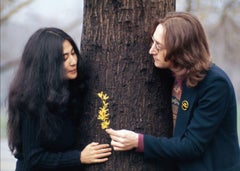 Yoko Ono and John Lennon holding flowers by a tree, Central Park, NYC 1973