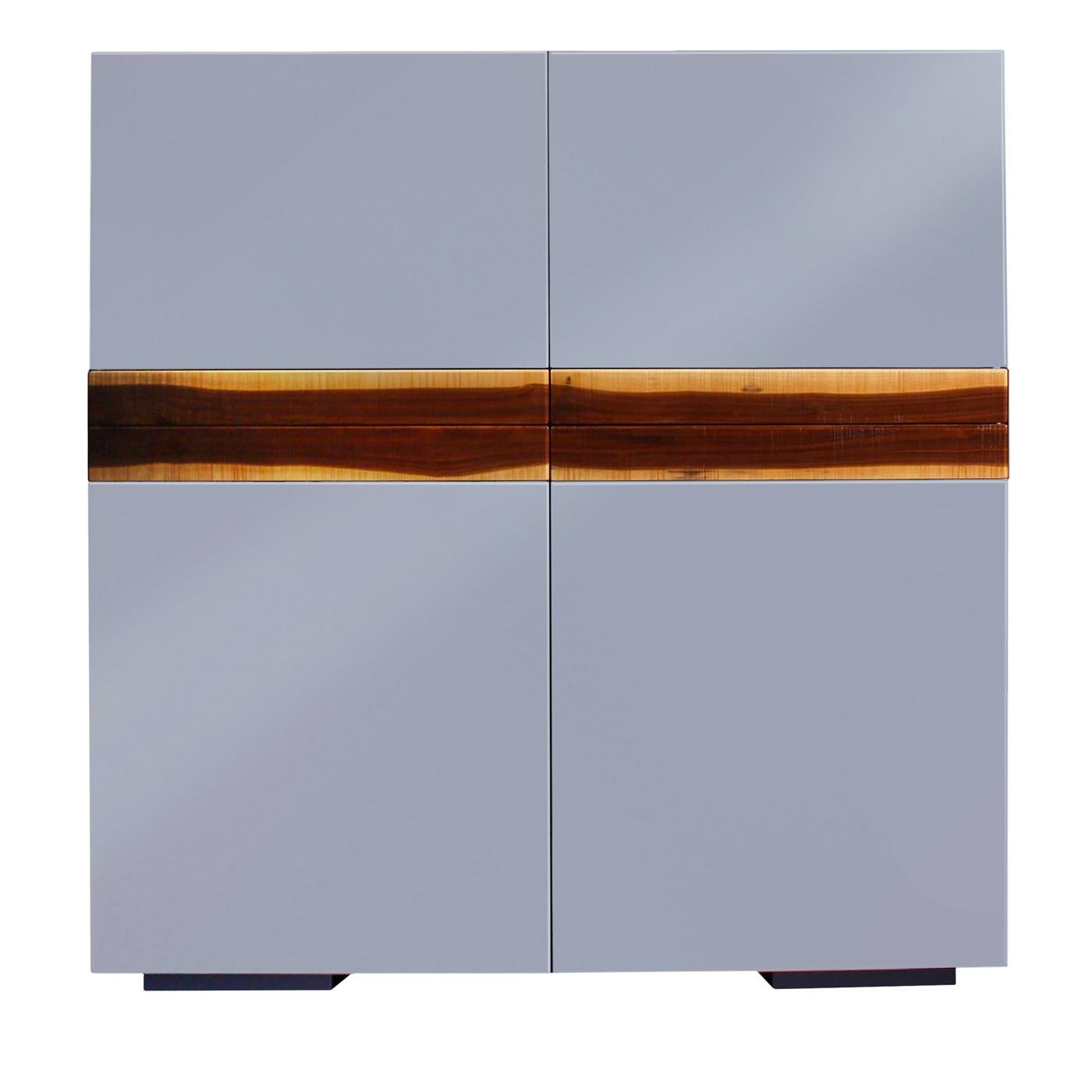 This bar cabinet exudes a sophisticated allure that will add a refined accent to a modern interior. Elegant and functional, this piece is composed of four doors boasting a shiny indigo polyurethane lacquer, and one cocktail tray showcasing the