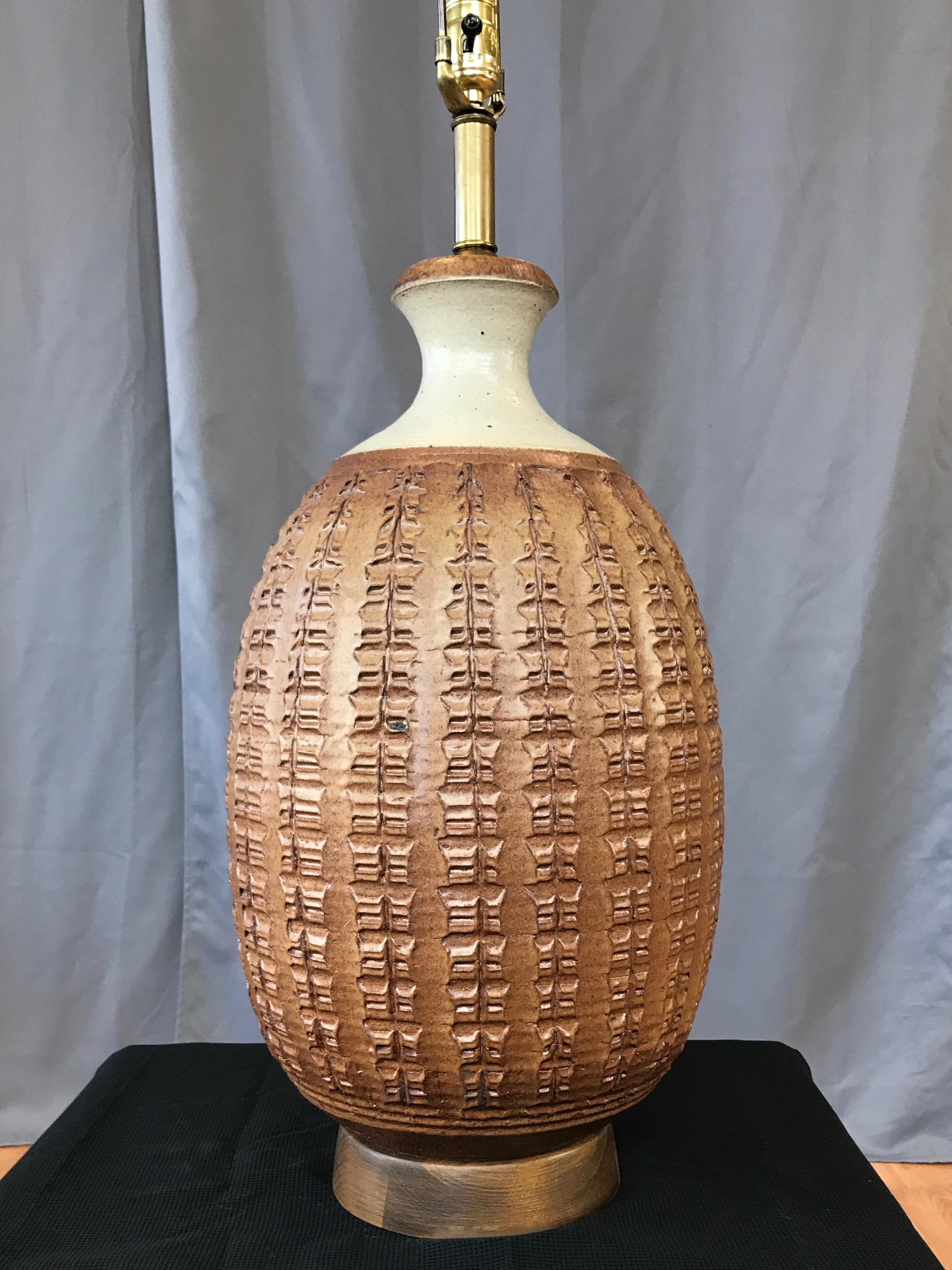 A monumental Affiliated Craftsmen Z Series stoneware table lamp by important and influential California Studio Pottery and ceramic artist Bob Kinzie.

Technically challenging and physically demanding extra-large hand-thrown Moroccan red clay form,