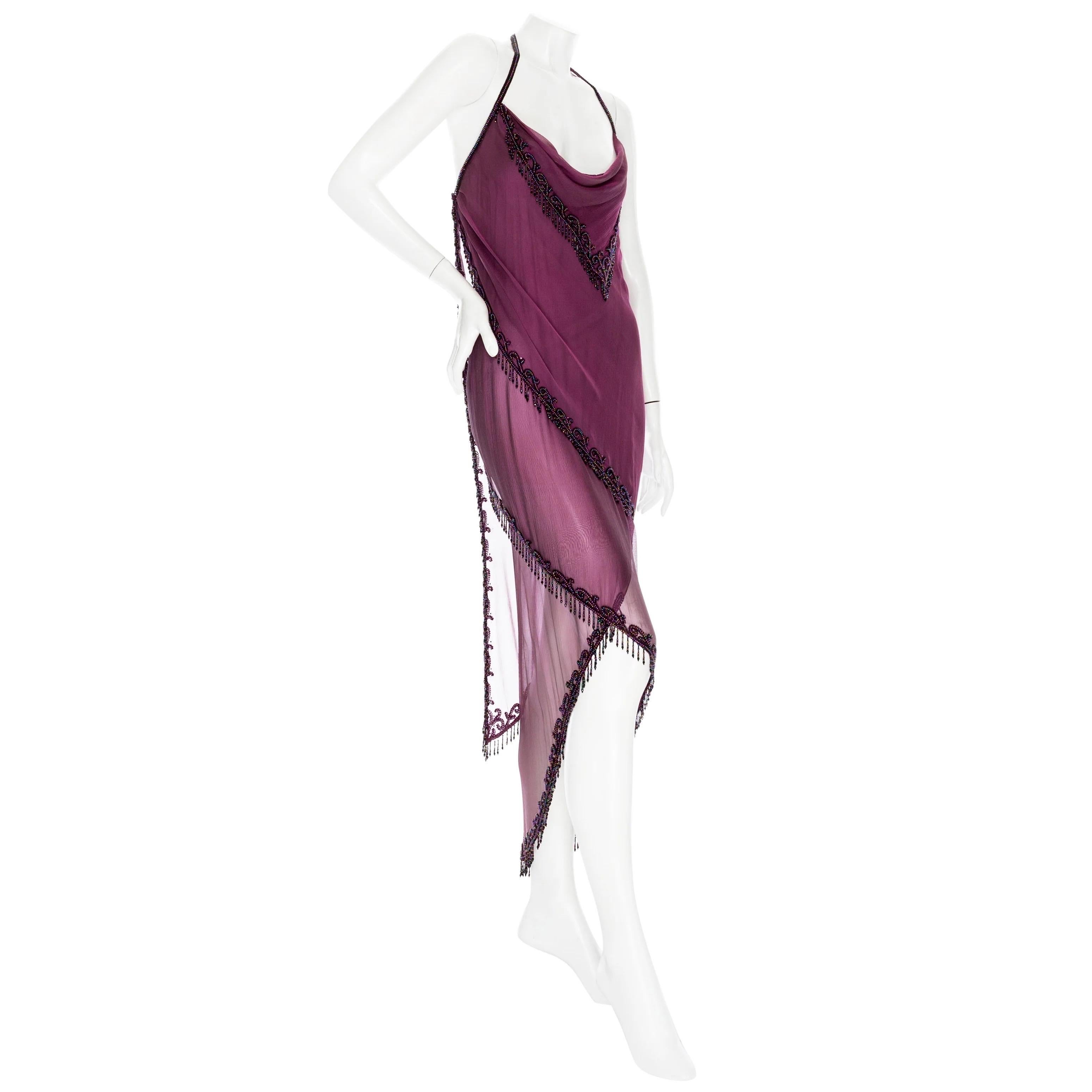 Bob Mackie 1980s Purple Silk Beaded Semi Sheer Halter Neck Dress

Vintage; circa 1980s
Deep Mauve / Purple
Semi sheer
Iridescent seed bead trim
Halter neck strap with hook and eye fastening
Cowl neck with draped triangular scarf
Wraparound