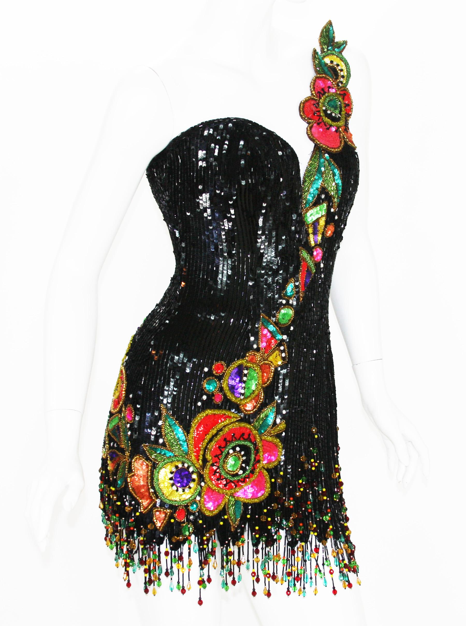 This is an EXQUISITE and BREATHTAKING 80's-does-20's mini dress by couture designer, Bob Mackie. 
It's beautifully detailed and hand beaded with millions of fringed glass beads and multi-colored sequins.
Designer size 6 ( please check measurements