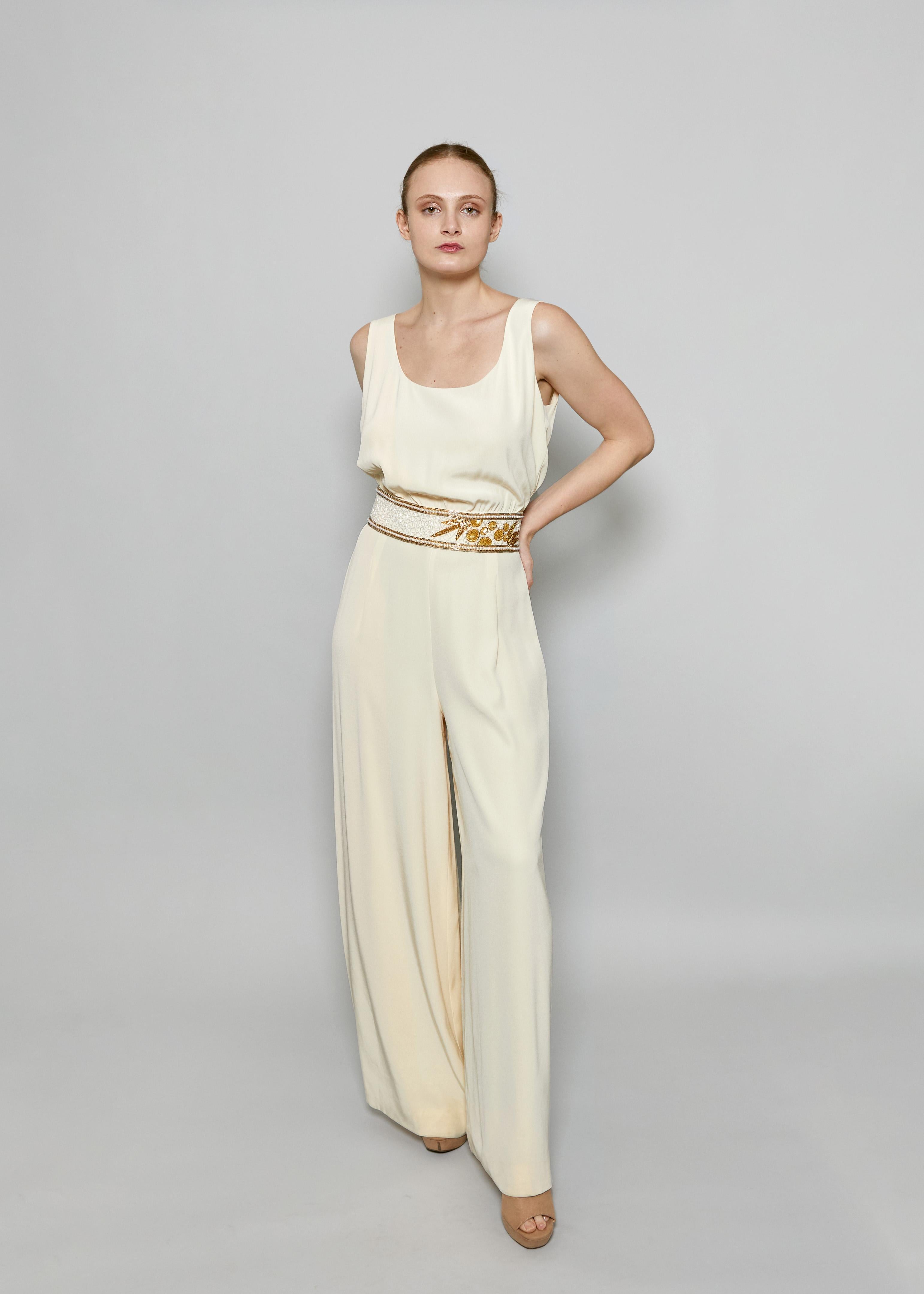 Indulge in luxury with the Bob Mackie Cream Jumpsuit. The creamy hue exudes elegance, while the beaded waist adds a touch of glamour. Make a statement at any event with this sophisticated and exclusive piece.



Condition: Excellent Vintage