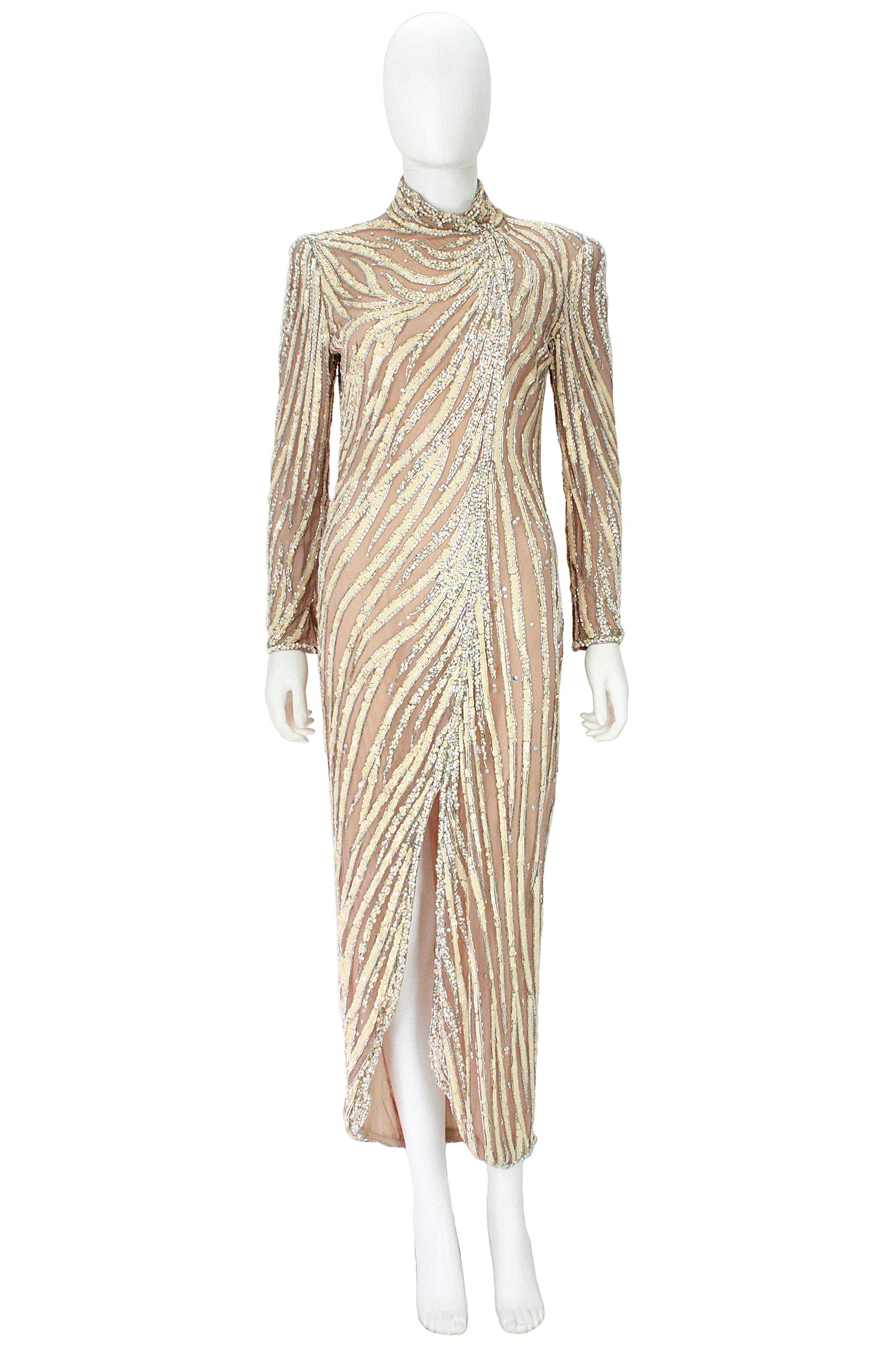 Bob Mackie gown 
Nude silk beaded and sequined 
Front slit 
Back zipper and zippers at the sleeve 
Gown marked size 12, however it frits more like an 8-10
Fully lined 
Lining has some discolorations from perspiration and stage makeup.
Lining issues