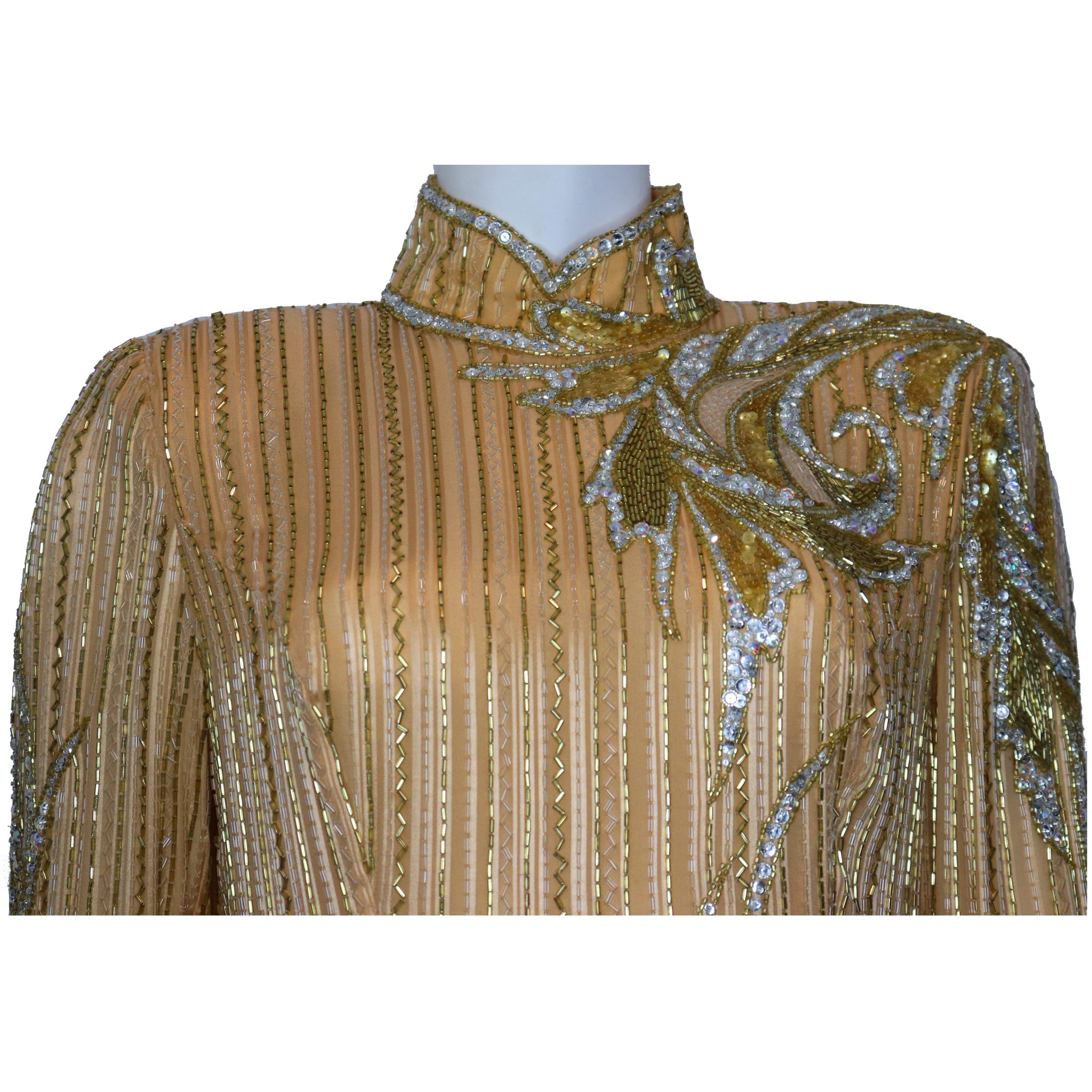 Bata Bob Mackie de cuello alto y manga larga con cuentas doradas Circa 1990s. En excelente estado 

Medidas - 

Talla 12 
Busto: 38
Cintura: 34
Caderas: 40
Longitud de la falda: 35 pulgadas
Longitud del dobladillo: 5 cm 
