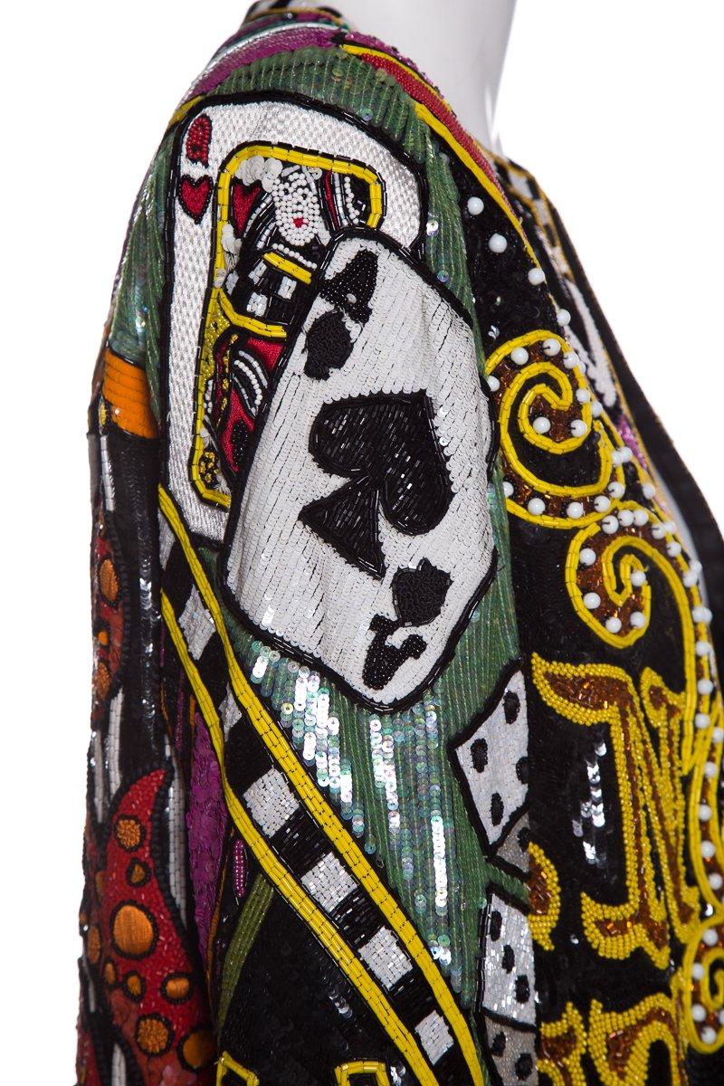 Bob Mackie multi-color bead embellished Monte Carlo jacket with casino-themed images, sequin detailing throughout dual hook closures at front.
This item is in good condition with light signs of wear. Wear includes some missing beading in various