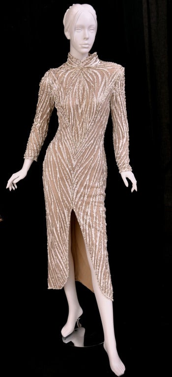 Bob Mackie

c. 1980's BOB MACKIE Nude Pearl Beaded Gown.
This gown is very similar to the design of the costume worn by RuPaul in Mackie's book Unmistakable Mackie
 Zip cuffs

Size 8

Worn once. Excellent condition! 
