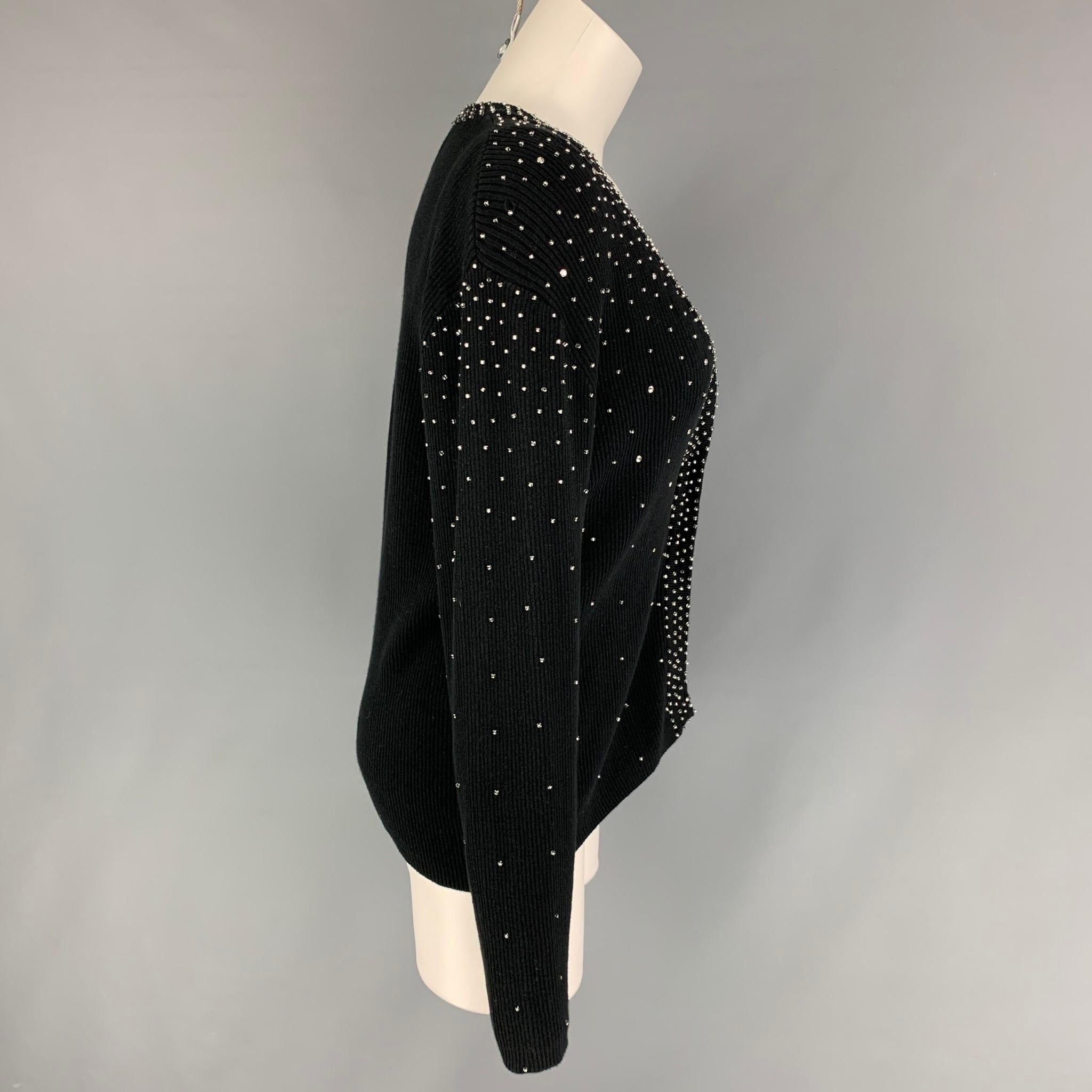 BOB MACKIE 2 Piece cardigan set comes in a black cotton featuring rhinestones, buttoned closure, and a matching camisole. 

Very Good Pre-Owned Condition.
Marked: L

Measurements:

-Cardigan
Shoulder: 17 in/
Bust: 38 in.
Sleeve: 24.5 in.
Length: 23