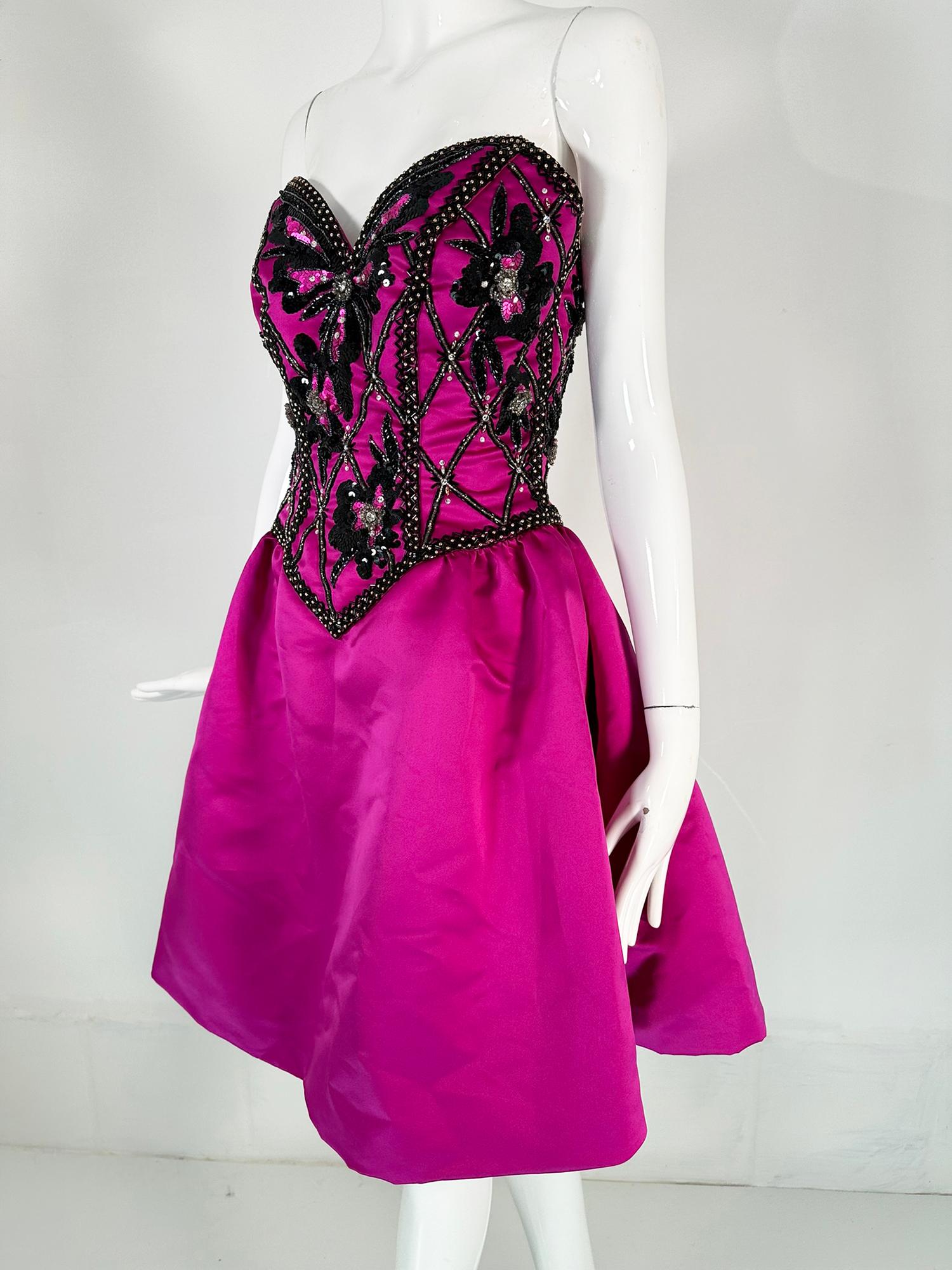 Bob Mackie Strapless beaded bodice evening dress with semi full skirt, in fuchsia satin. This gorgeous dress is perfect for any big night. The bodice is sewn with black glass tube beads, black sequins, gunmetal seed beads, crystal rhinestones &