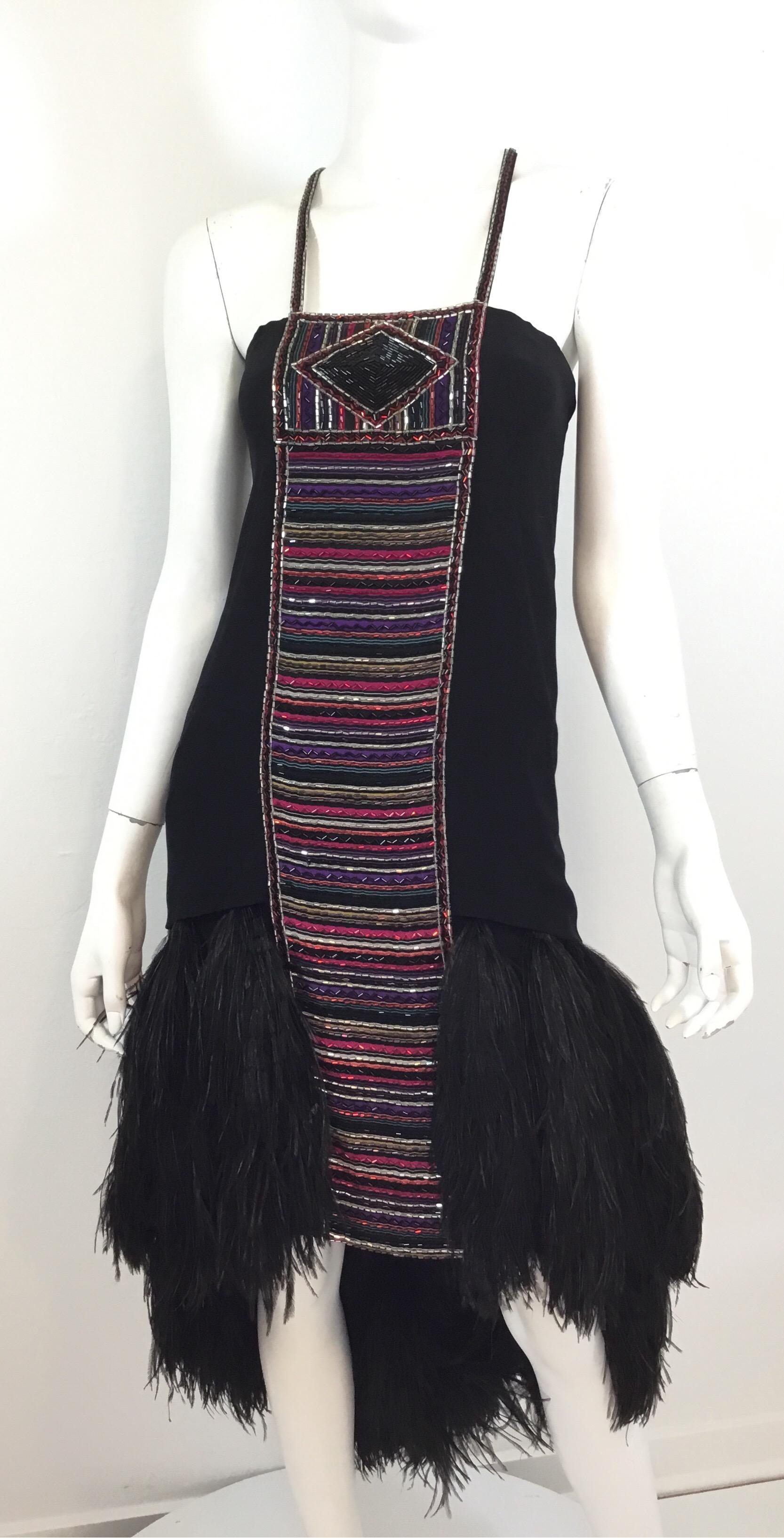 Bob Mackie embellished dress featured in black with multicolored bead detail throughout and a Ostrich Maribou feather hem. Dress is fully lined and has a back zipper fastening along with a hook and eye closure for the shoulder straps. Excellent