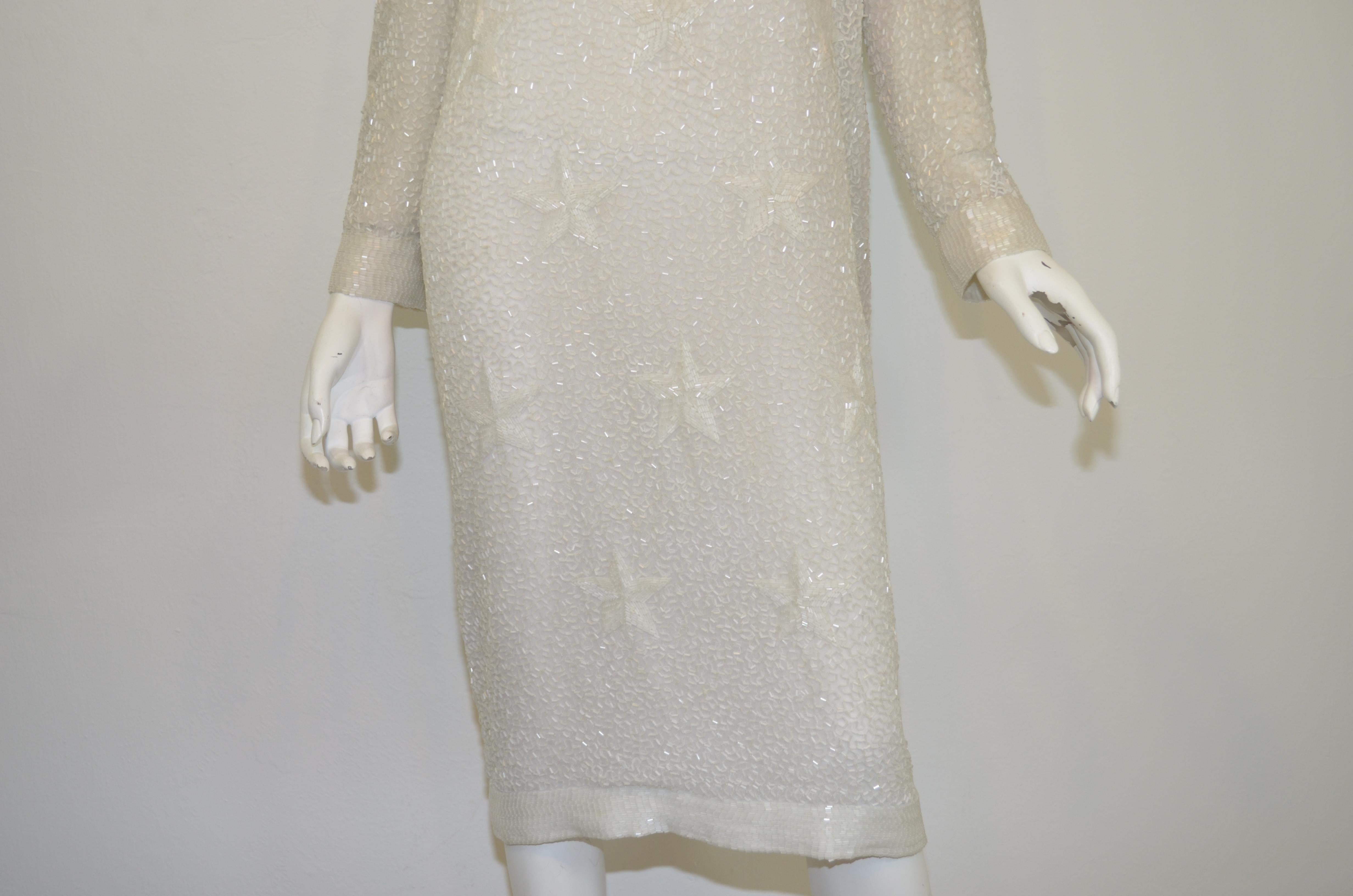 AMAZING Bob Mackie fully beaded dress featured in an off-white color with a star motif. Dress has a deep V-neckline and a back zipper fastening. Fully lined.

Measurements: 
Bust 40”, waist 38”, hips 41”, length 43”, sleeves 24”, shoulder to