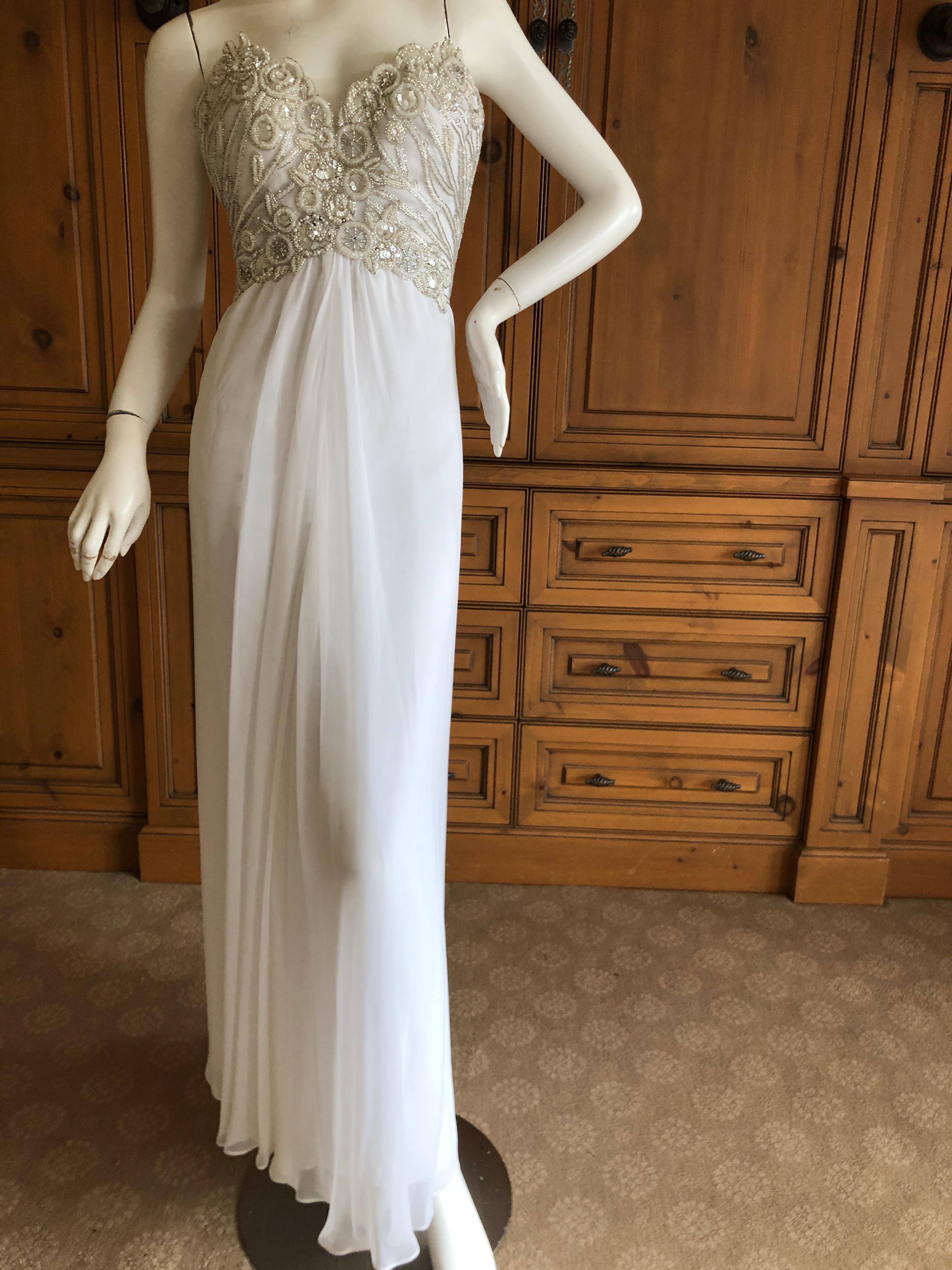 Bob Mackie Vintage Ivory Evening Gown with Silver Beaded Bodice and Shawl.
Ivory with silver bead accents, with clear crystals
So much prettier than the photos, please use zoom feature to see details.
Size 6
Bust 32
