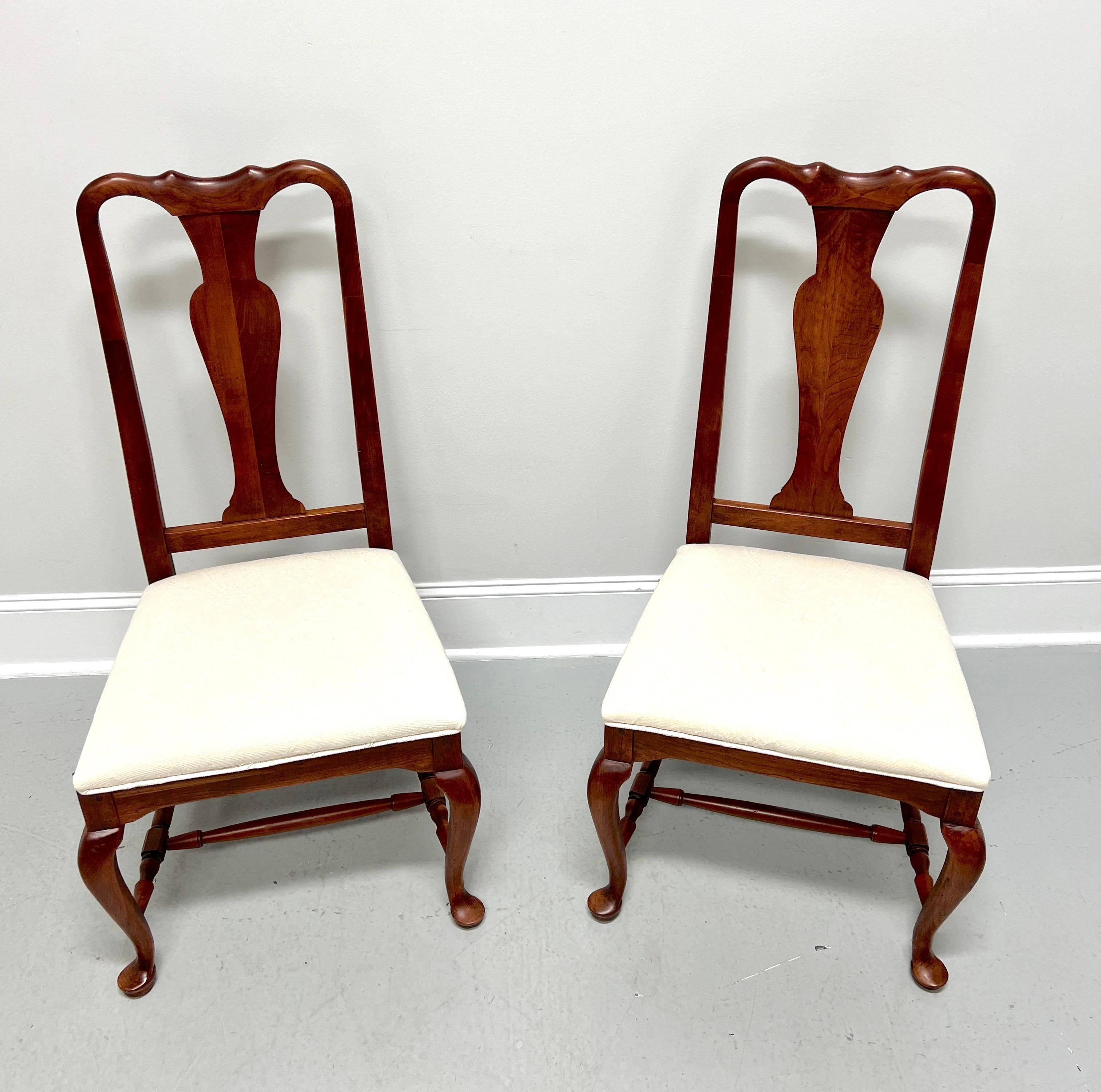 A pair of Queen Anne style dining side chairs by Lexington Furniture, from their Bob Timberlake Collection. Solid cherry wood, carved crest rail & center backrest, upholstered seat in a neutral off-white fabric, carved apron at legs, turned