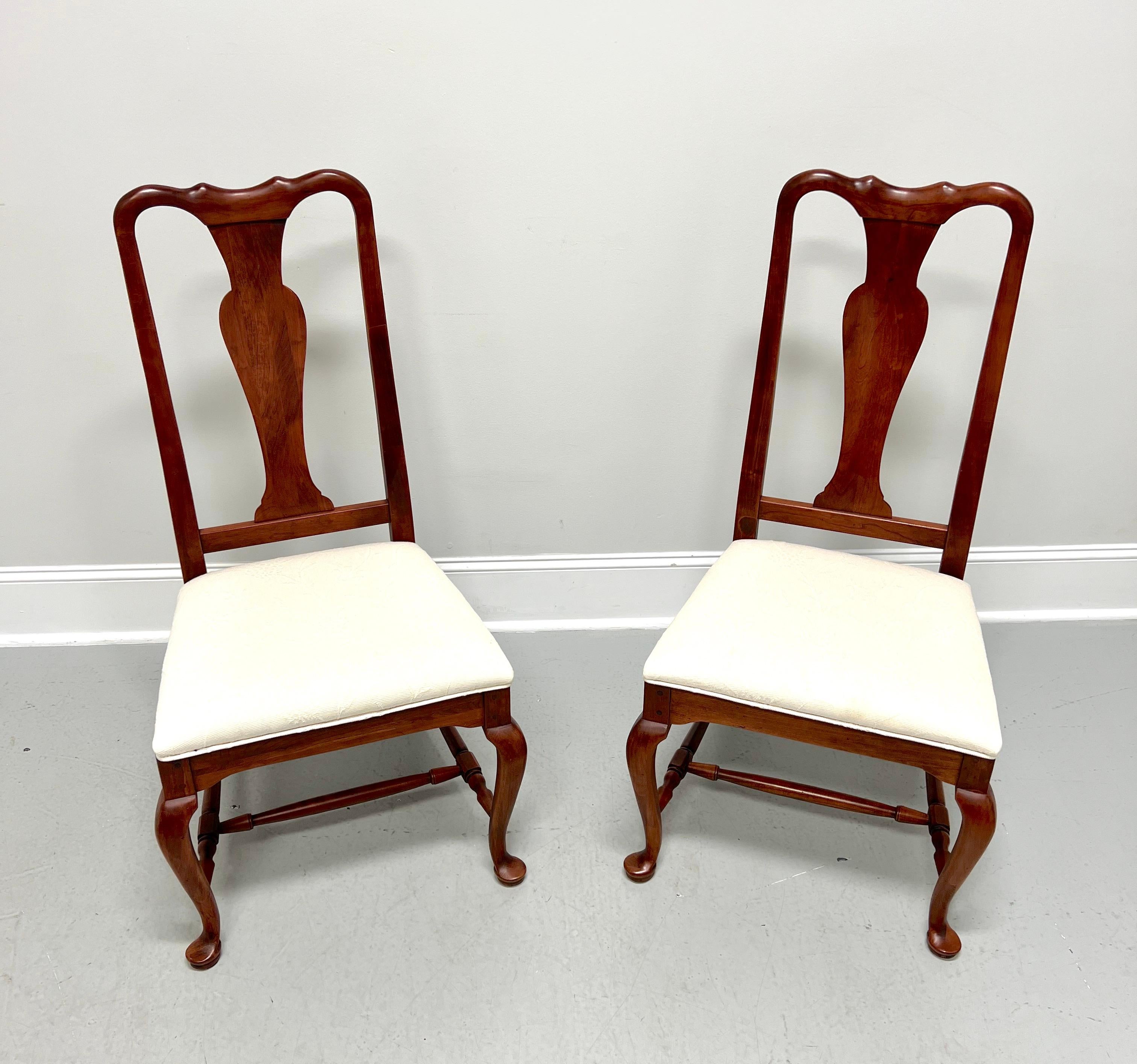 A pair of Queen Anne style dining side chairs by Lexington Furniture, from their Bob Timberlake Collection. Solid cherry wood, carved crest rail & center backrest, upholstered seat in a neutral off-white fabric, carved apron at legs, turned
